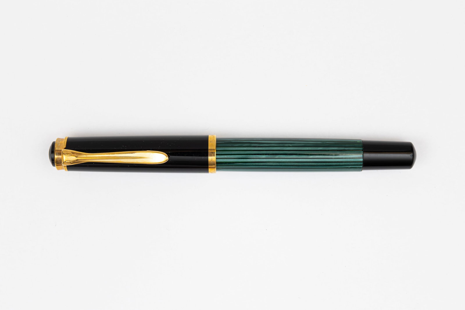 Pelikan M400 Green Striated Pre 1997 Fountain Pen: Pelikan M400 green striated fountain pen. Early 1990’s example marked Germany on cap band, this the first version of the M400 with fine 14K flexible nib. Length 4 7/8” and 5 3/4” posted,