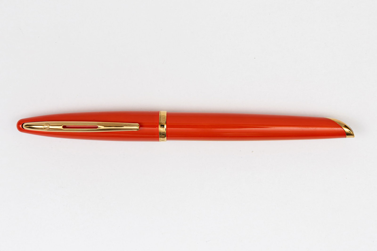 Waterman Carene Coral Fountain Pen, Boxed: Waterman Carene Coral fountain pen with box and papers. Coral lacquer finish with gold trim and 18K fine nib. Length 5 5/8” and 5 3/4” posted, filling mechanism cartridge/converter fill (c