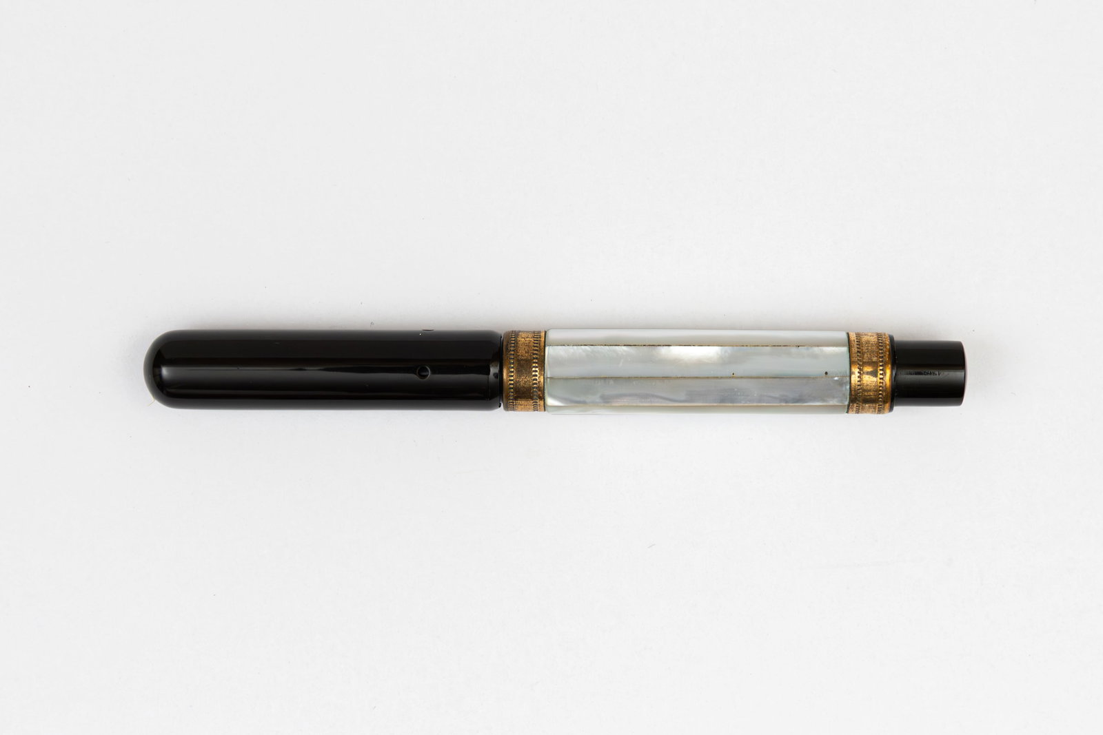 Mother of Pearl Salz Brothers Faceted Barrel Fountain Pen: Salz Brothers faceted mother of pearl fountain pen. Unusual screw down cap with faceted mother of pearl barrel flanked with gold bands, similar examples in black hard rubber have been found with Salz