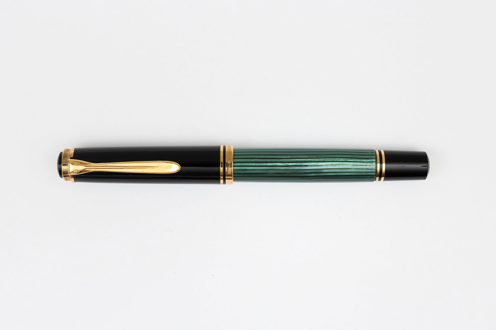 Pelikan M800 W Germany Green Striated Fountain Pen: Pelikan M800 green striated fountain pen, circa 1989-1997. An early M800 marked Pelikan W. Germany on cap band with 18K extra fine two-tone nib. Length 5 1/2” and 6 3/8” posted, filling me