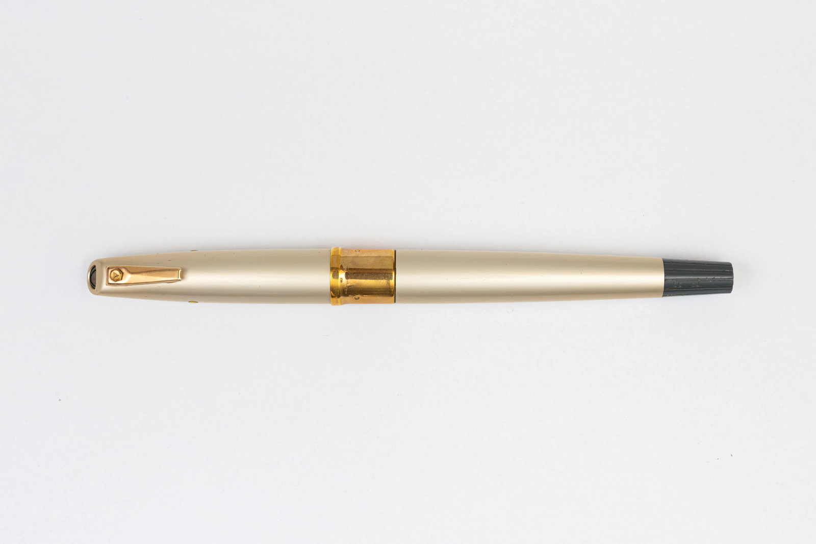 Pilot Capless First Model C-600MW Twist Retractable Fountain Pen: Pilot Capless C-600MW fountain pen, circa 1963. This was the first of the Pilot Capless models. Metaruby, satin finish with yellow knobs on the either side of the cap, gold trim and grey end. The nib