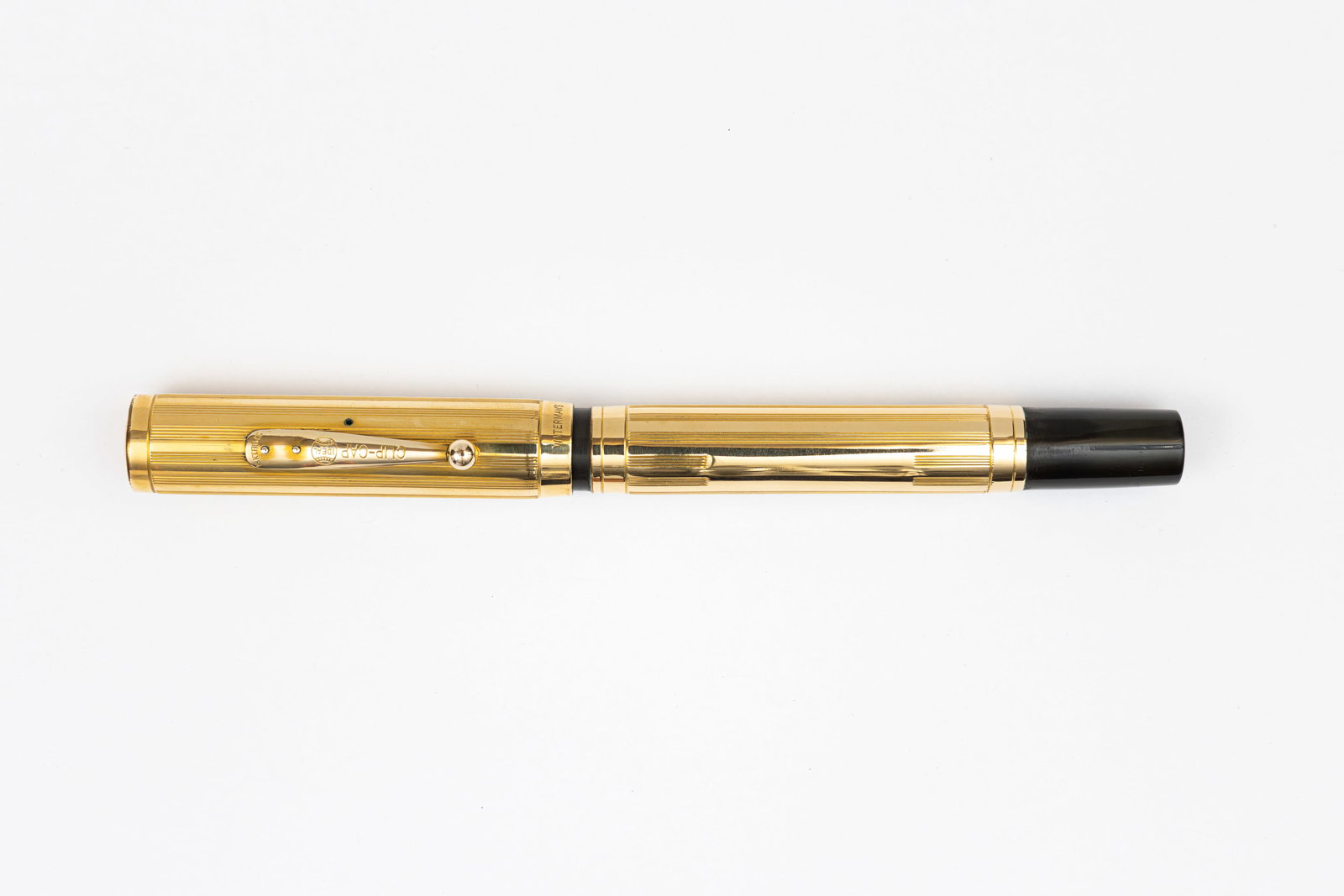 Waterman 0552 Sheraton Gold Filled Overlay Fountain Pen: Waterman Ideal 0552 Sheraton gold filled overlay fountain pen. Sheraton lined pattern gold filled overlay over black hard rubber with gold filled clip. Overlay with minor marks, imprints weak, Waterma
