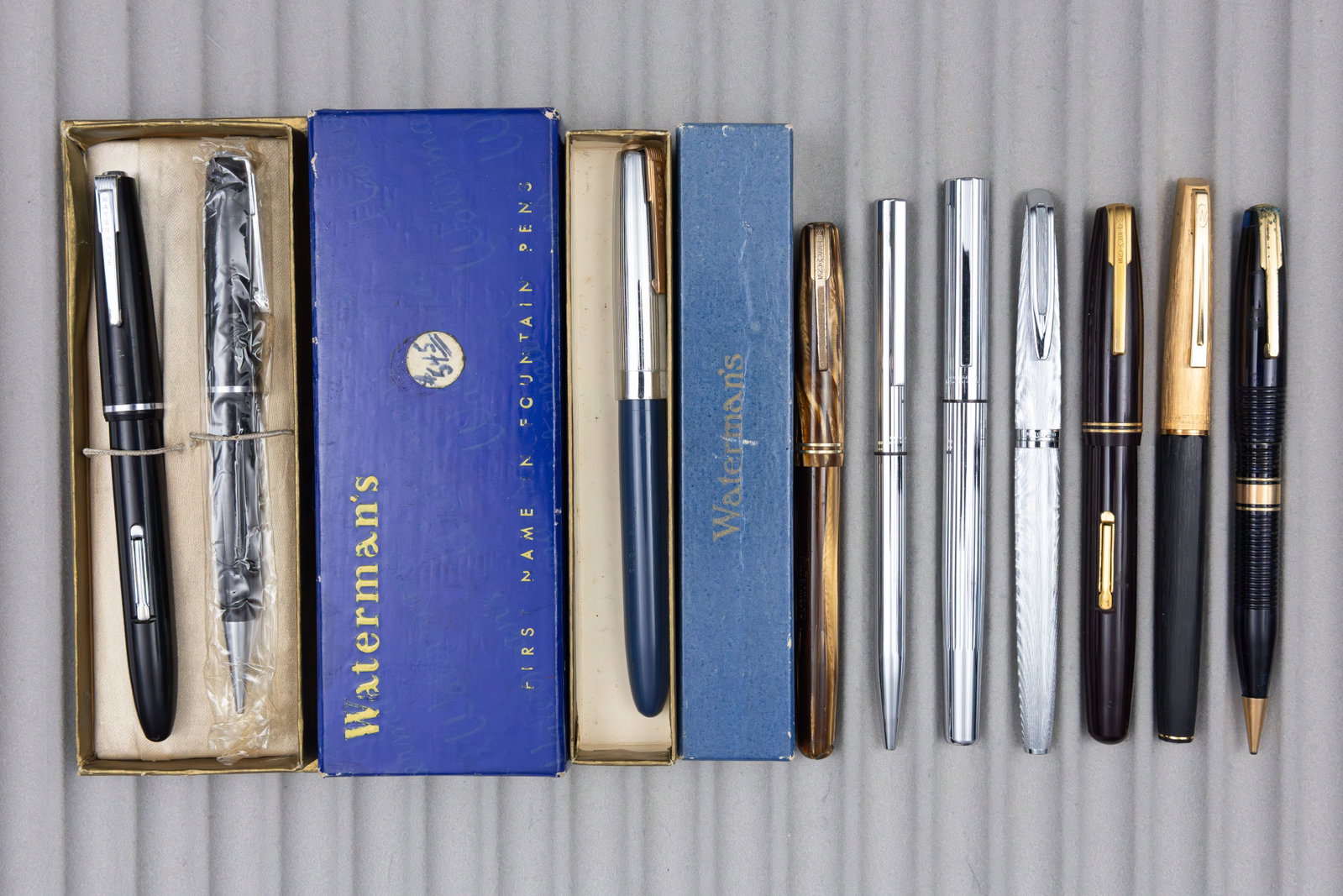 Waterman Fountain Pen, Ballpoint and Pencil Lot (10): Waterman pen lot (10). Four Waterman lever fillers with 14K nibs, one cartridge filler with 18K nib and one later French steel nib pen along with one rollerball, ballpoint and two pencil. Overall