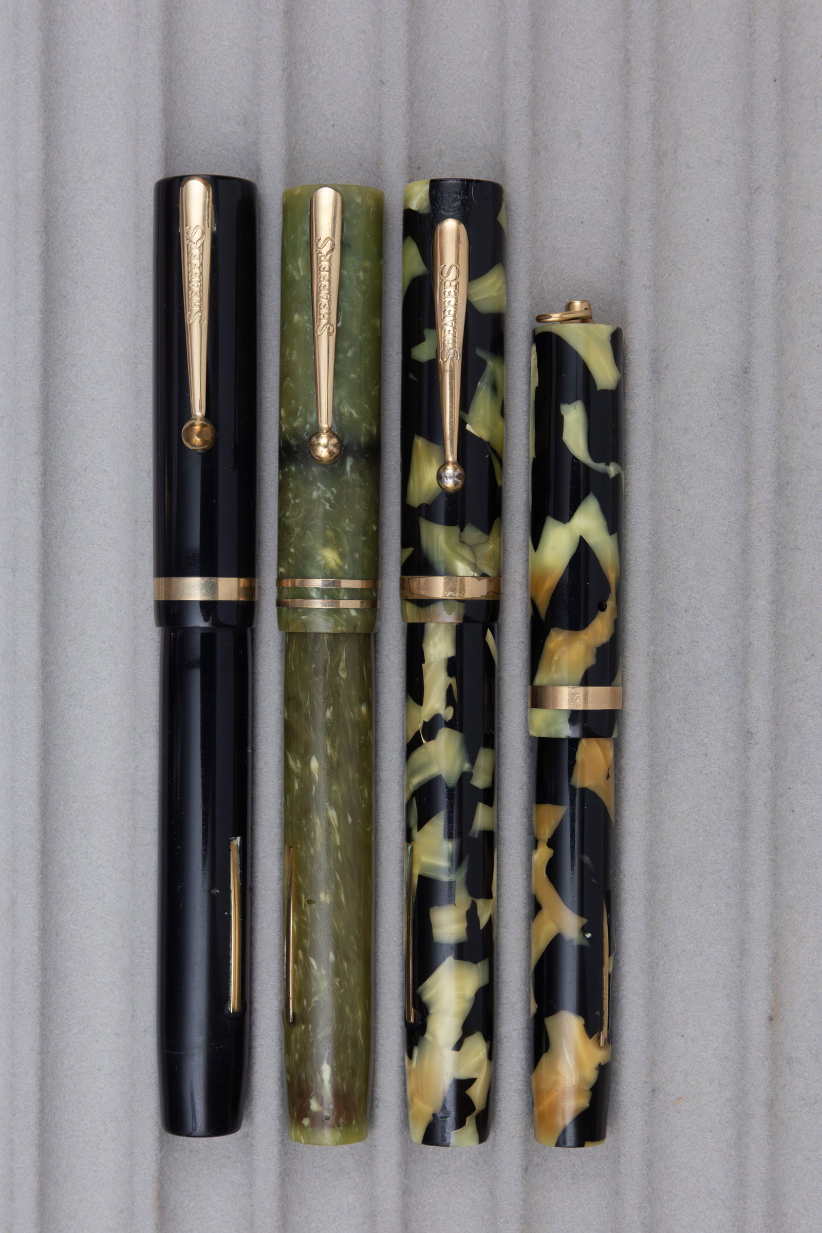 Sheaffer Flattop Oversized and Ring Top Fountain Pens (4): Sheaffer Flattop fountain pens (4). Three oversized Sheaffer Flattop fountain pens, all with 14K Lifetime nibs, caps with cracks, one barrel with name engraved along with smaller ring top Flattop pen 