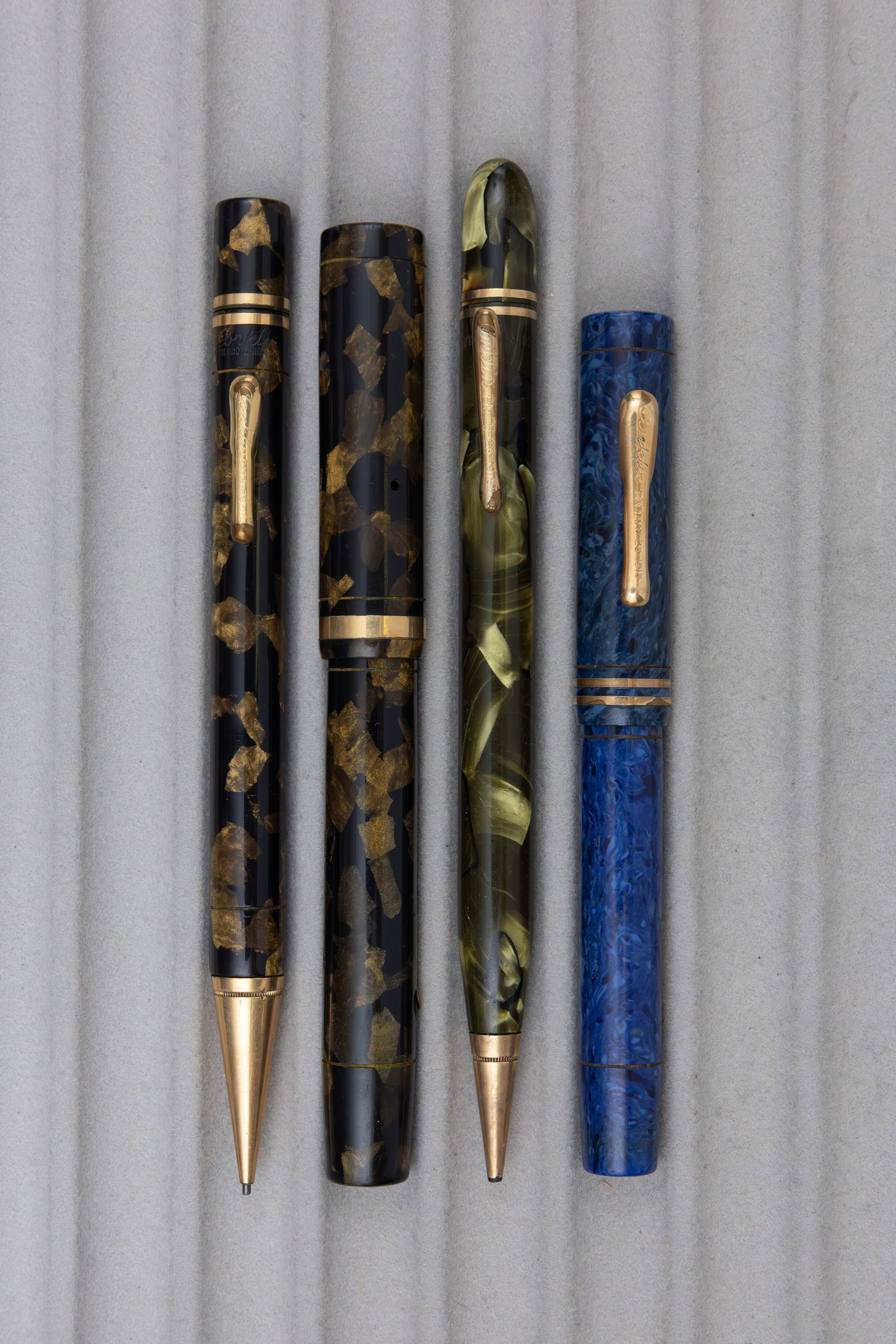 Conklin Endura and Symmetric Fountain Pens, Pencils Lot (4): Conklin Endura and Symmetric fountain pens and pencils. Endura senior set in black and bronze with box (fountain pen missing clip) along with Endura in Sapphire blue and Symmetric oversized pencil in 