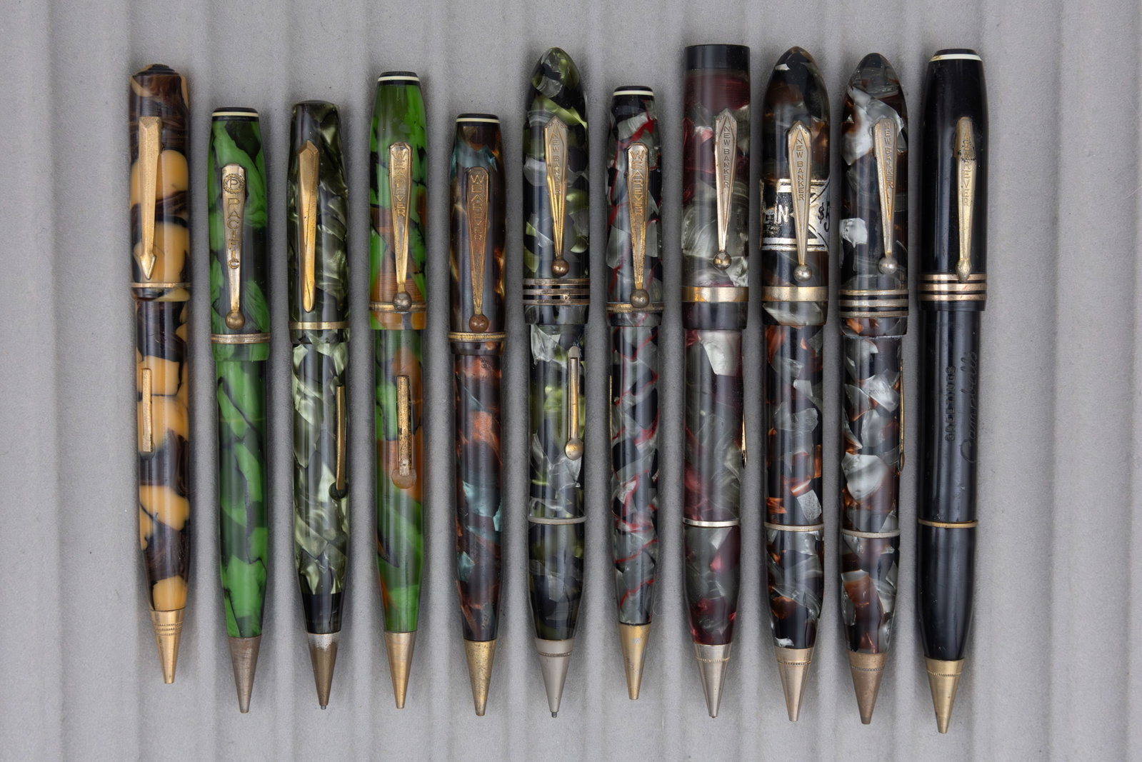 Assorted Marbleized Fountain Pen Pencil Combinations (11), Lot I: Assorted celluloid fountain pen/pencil combos (11). This lot consists of brands from M to Z alphabetically, brands such as New Banker, Remington, Waltham, Wearever and others can be found in these