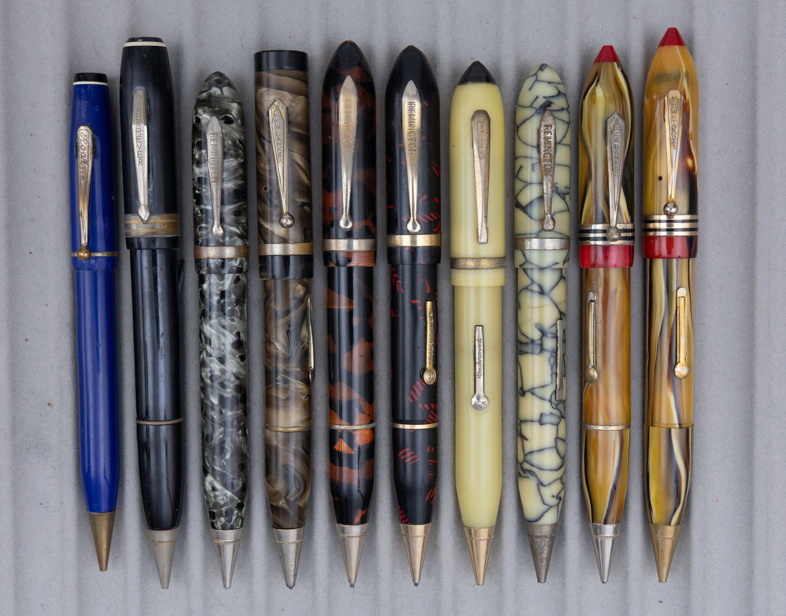 Assorted Marbleized Fountain Pen Pencil Combinations (10), Lot E: Assorted celluloid fountain pen/pencil combos (10). This lot consists of brands from M to Z alphabetically, brands such as New Banker, Remington, Waltham, Wearever and others can be found in these