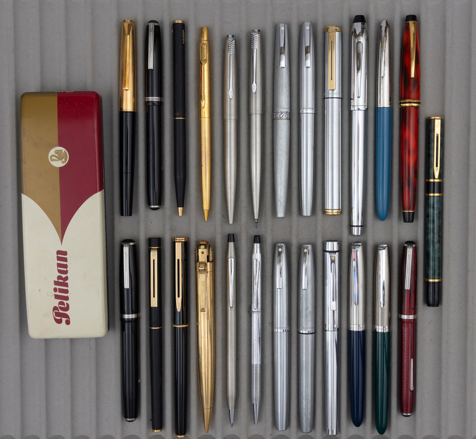 Assorted Mid Century, Modern Fountain Pens, Ballpoints and Pencils (25): Assorted pens and pencils. Fountain pens, ballpoints and pencils by Cross, Esterbrook, Parker, Pelikan (with original box), Ronson, Sheaffer and Waterman. Overall as is mixed condition.