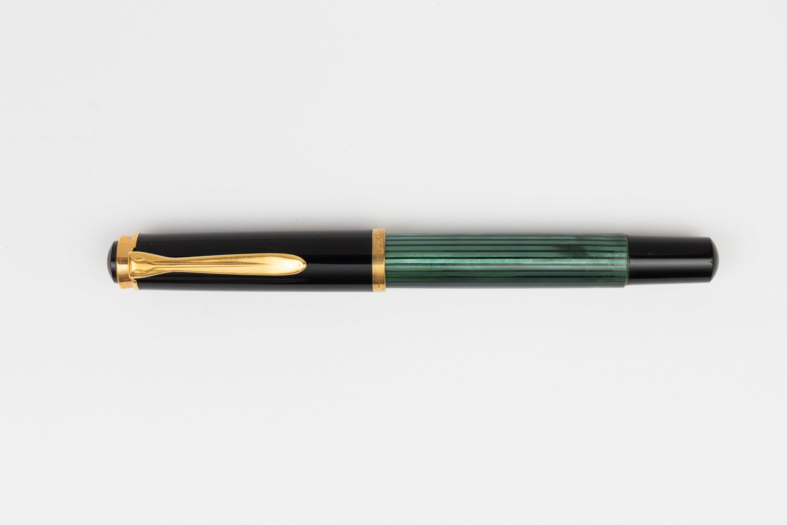 Pelikan M400 Pre 1997 Green Striated Fountain Pen: Pelikan M400 green striated fountain pen. Early 1990’s example marked Germany on cap band, this the first version of the M400, hard medium HM marked 14K nib. Length 4 7/8 inches and 5 3/4