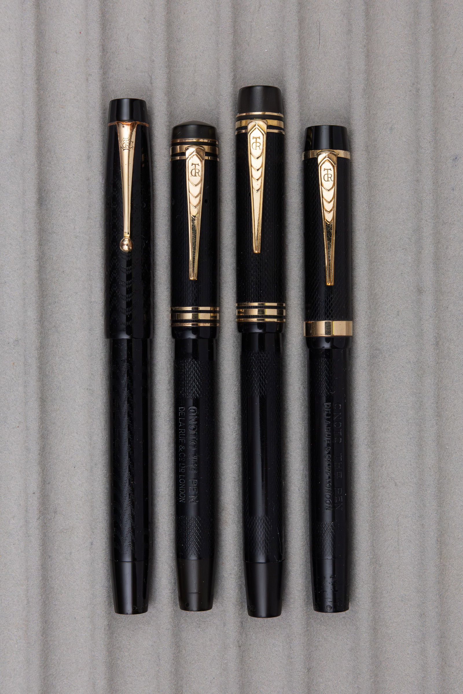 Onoto De La Rue Black Chased Hard Rubber Fountain Pens (4): Onoto De La Rue black chased hard rubber fountain pens (4). Onoto black chased hard rubber 2 and 5 size fountain pens, all with correct 14K Onoto flexible nibs, (either fine, medium or broad). All