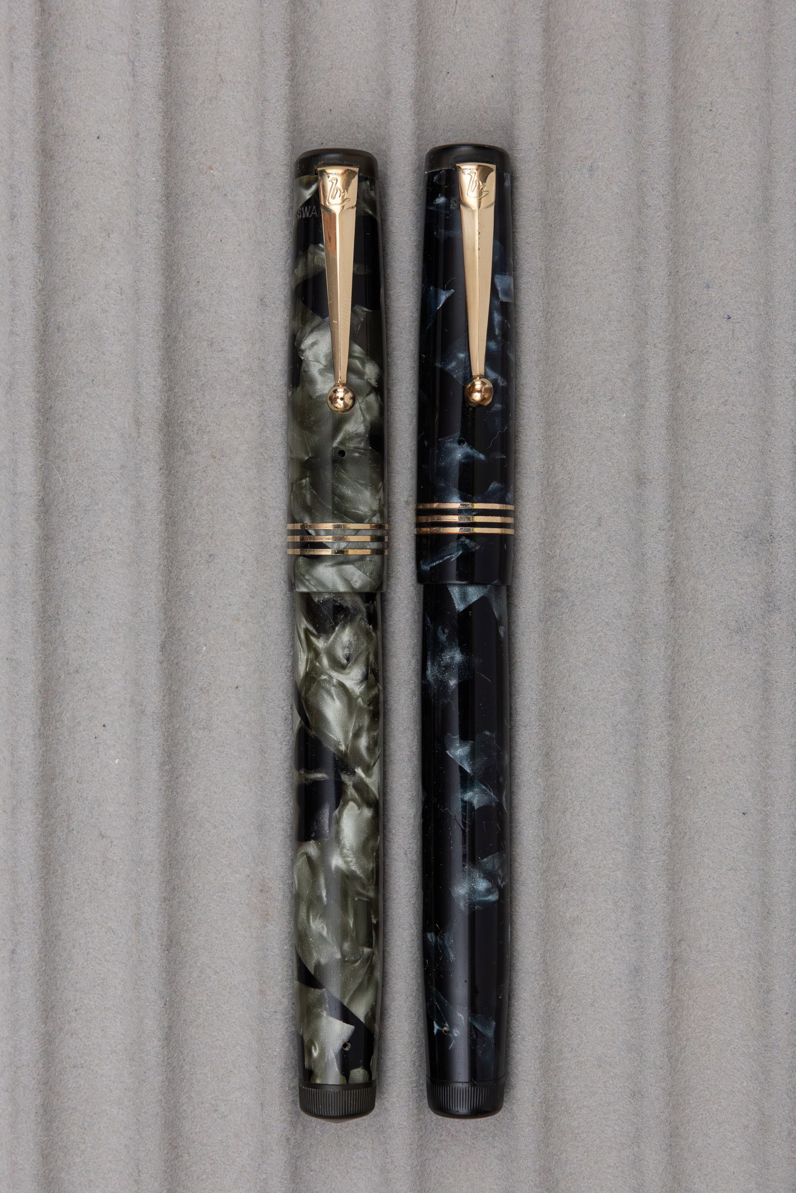 Mabie Todd Swan 4 Size Marbleized Leverless Fountain Pens (2): Mabie Todd Swan marbleized fountain pens. 4 size Leverless Mabie Todd Swan fountain pens in blue/black marble (USA made) and grey/black marble (English made) with Swan 4 14K nibs, one fine and one
