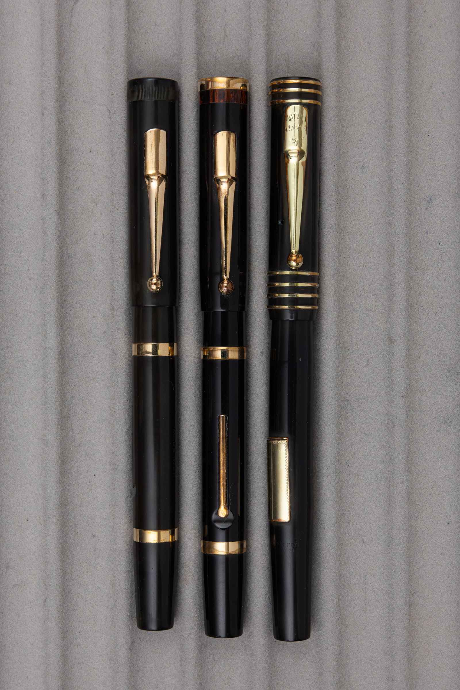Mabie Todd Swan Black Hard Rubber Fountain Pens (3): Mabie Todd Swan black hard rubber fountain pens (3). Swan Self-Filler with plain cap and gold barrel bands, SF230 with mottled top and gold barrel bands along with black hard rubber example with gold 