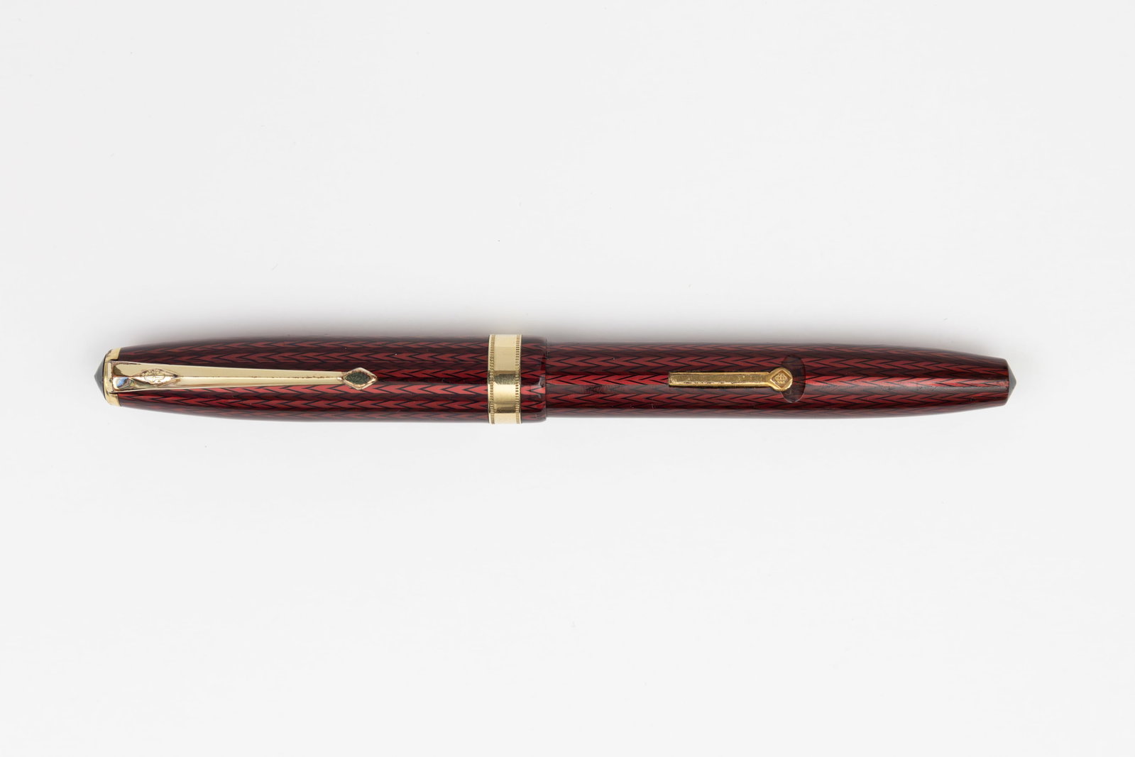 Conway Stewart 76 Red Herringbone Fountain Pen: Conway Stewart 76 red herringbone fountain pen, 1955-60’s. Bright red and black herringbone pattern with gold filled trim and correct Conway Stewart 5 14K medium nib. Length 5 3/8 inches and 6