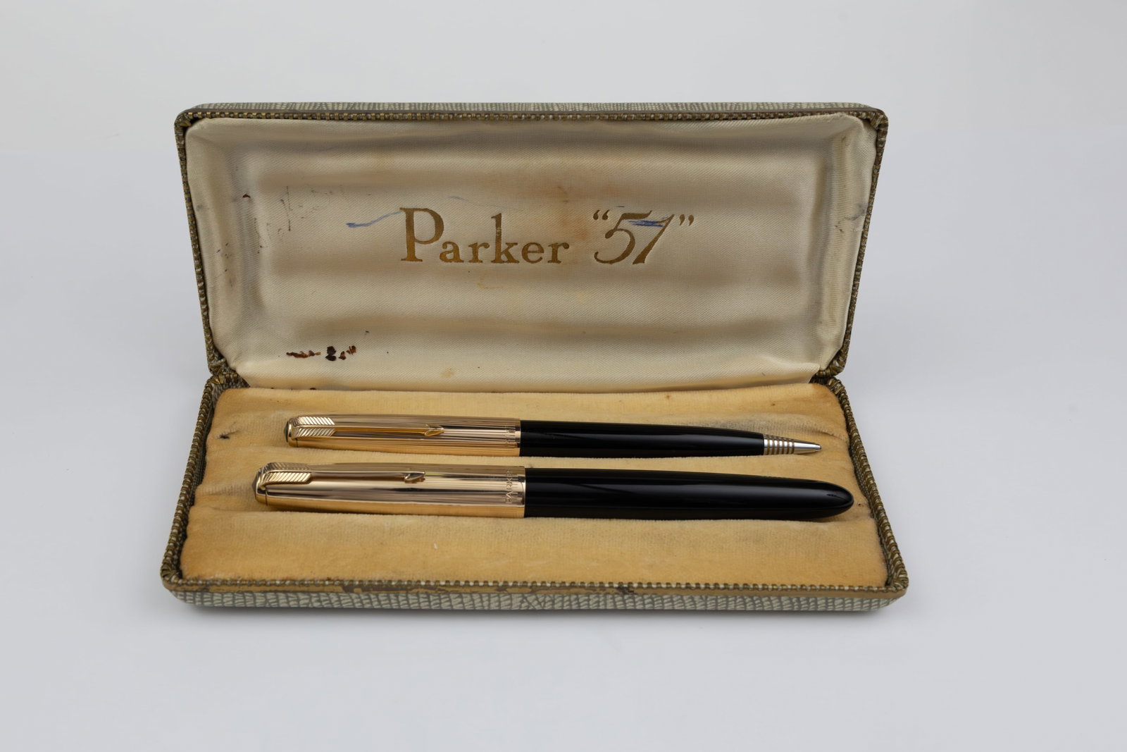 Parker 51 Aerometric Fountain Pen Set, Gold Filled Caps, Boxed: Parker 51 Aerometric fountain pen and pencil set, circa 1950’s. English with rolled gold filled caps and black barrels, medium 14K nib. Length 5 1/4 inches (pencil) and 5 1/2 inches (pen),