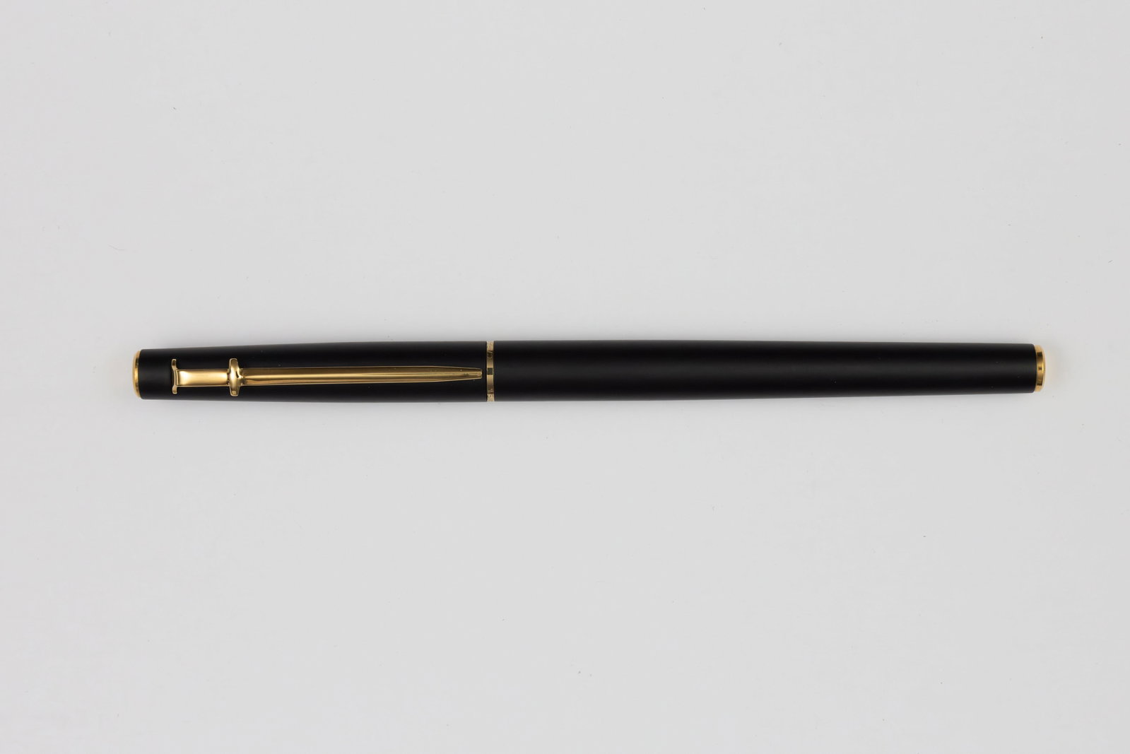 Caran dAche Madison Matte Black Fountain Pen, B 14K Nib, Boxed: Caran dAche Madison Matte Black fountain pen with box, outer box and papers. Madison model with T-style clip and broad 14K nib. Length 5 3/8 inches and 5 5/8 inches posted, filling mechanism