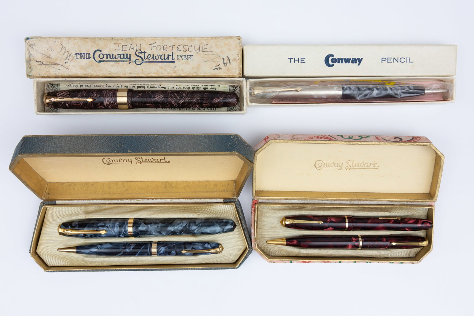 Conway Stewart Boxed Fountain Pens and Pencils (6): Conway Stewart fountain pens and pencils (6). Model 60 Executive in Red Hatched, 84 blue marble set, 355 Dinkie red marble set and 44 pencil. Three fountain pens with Conway Stewart 14K nibs. Overall