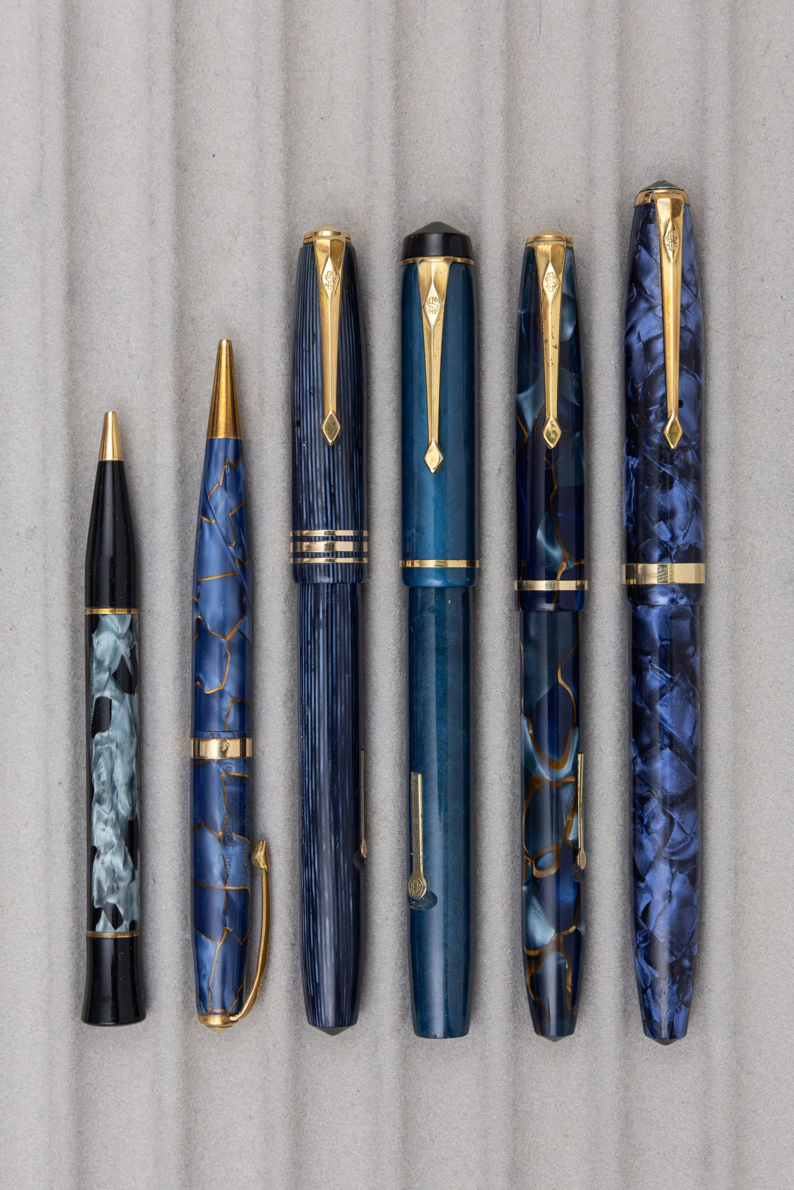 Conway Stewart Blue Marbleized Fountain Pens and Pencils (6): Conway Stewart blue marble fountain pens and pencils (6). Conway Stewart 12, 36, 85L and 759 fountain pens with 14K Conway nibs (three flexible) along with 26 and Nippy mechanical pencils. Overall goo