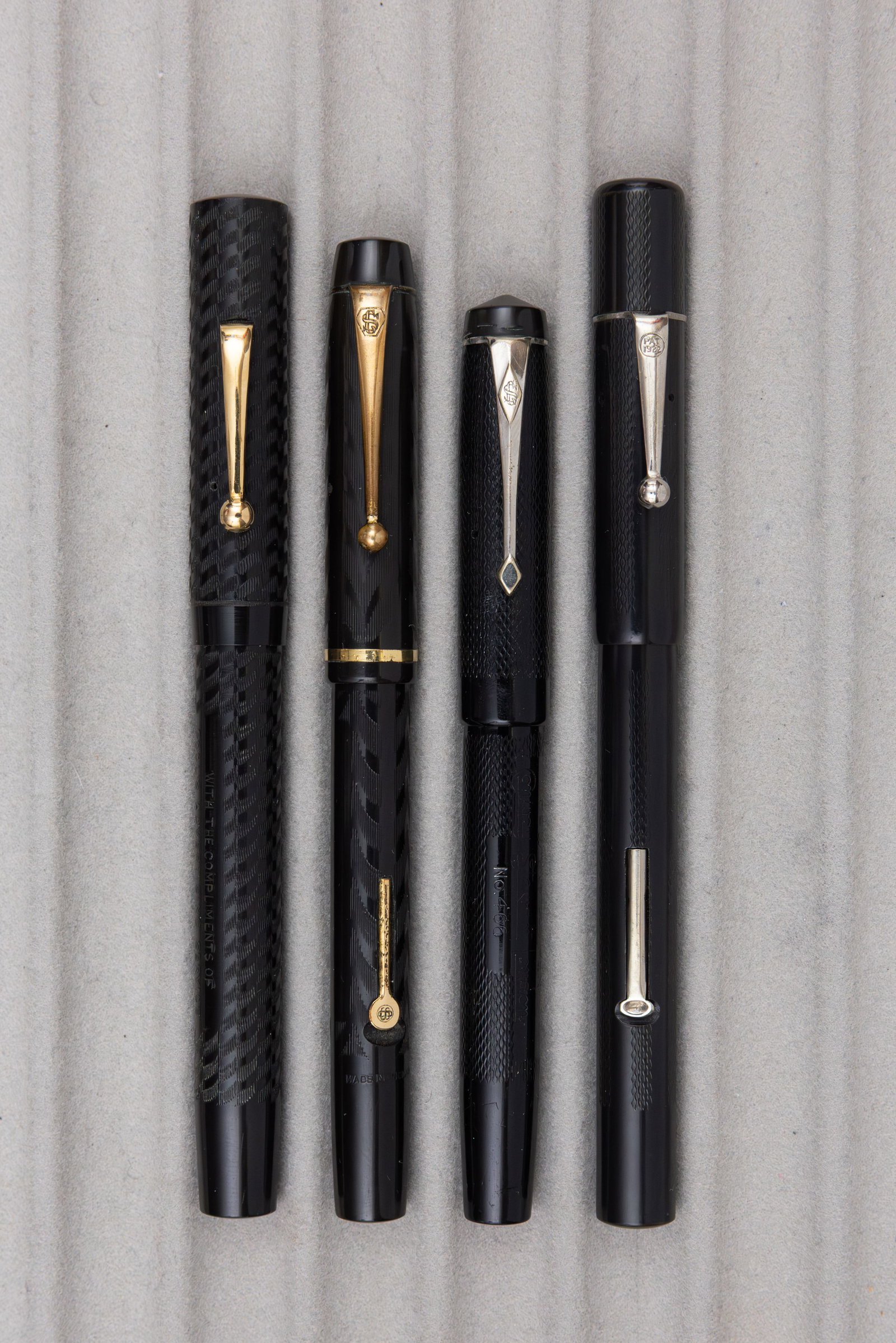 Conway Stewart and Other Black Chased Hard Rubber Fountain Pens (4): Conway Stewart and other black chased hard rubber fountain pens. Two Conway Stewart pens, Universal 466 and unmarked model pen with 14K Conway Stewart nibs, along with unmarked pen with company
