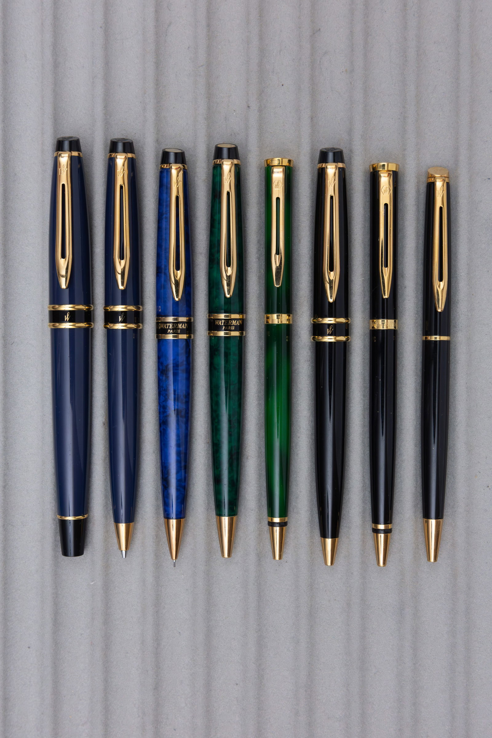 Waterman Expert, Hemisphere and Preface Pens and Pencils (8): Waterman ballpoint pens and pencils (8). Waterman Expert I rollerball and pencil in navy blue, pencil in blue marble and ballpoints in green marble and black along with Preface ballpoint in green marb