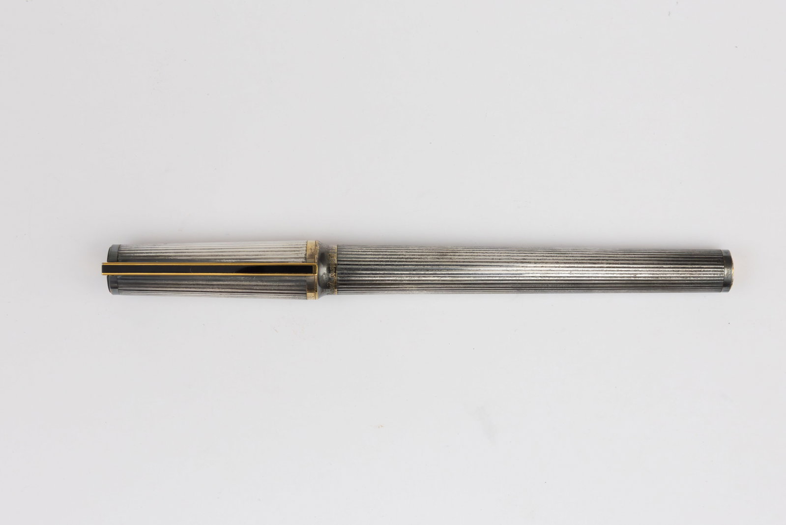 ST Dupont Montparnasse Silver Godron Rollerball Pen: S.T. Dupont Montparnasse silver Godron rollerball pen. Silver with gold trim, likely plated with no metal content markings on pen, serial number on clip. Length 5 3/8”, refill dry. Overall good 