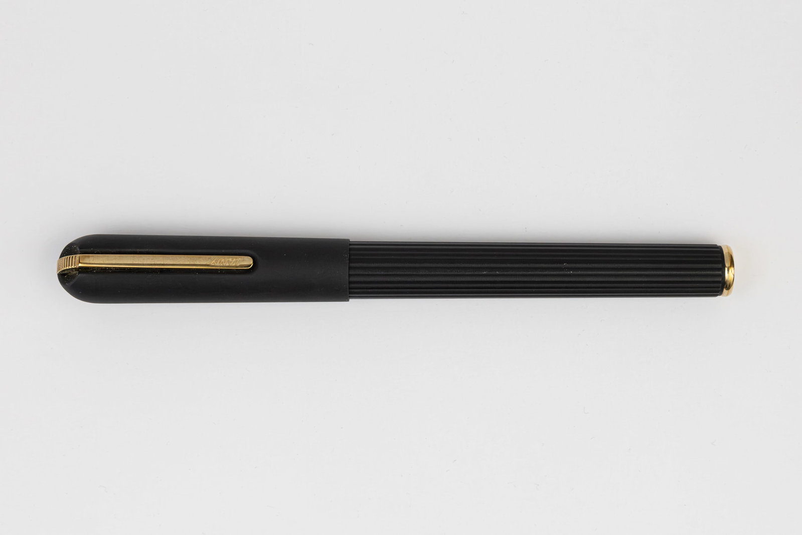 Lamy Persona Black Titanium Oxide Fountain Pen: Lamy Persona fountain pen in black titanium oxide finish. Made in several finishes, this the black titanium oxide with gold trim. This model with retracted pivoting clip and Lamy 14K fine nib. Length 