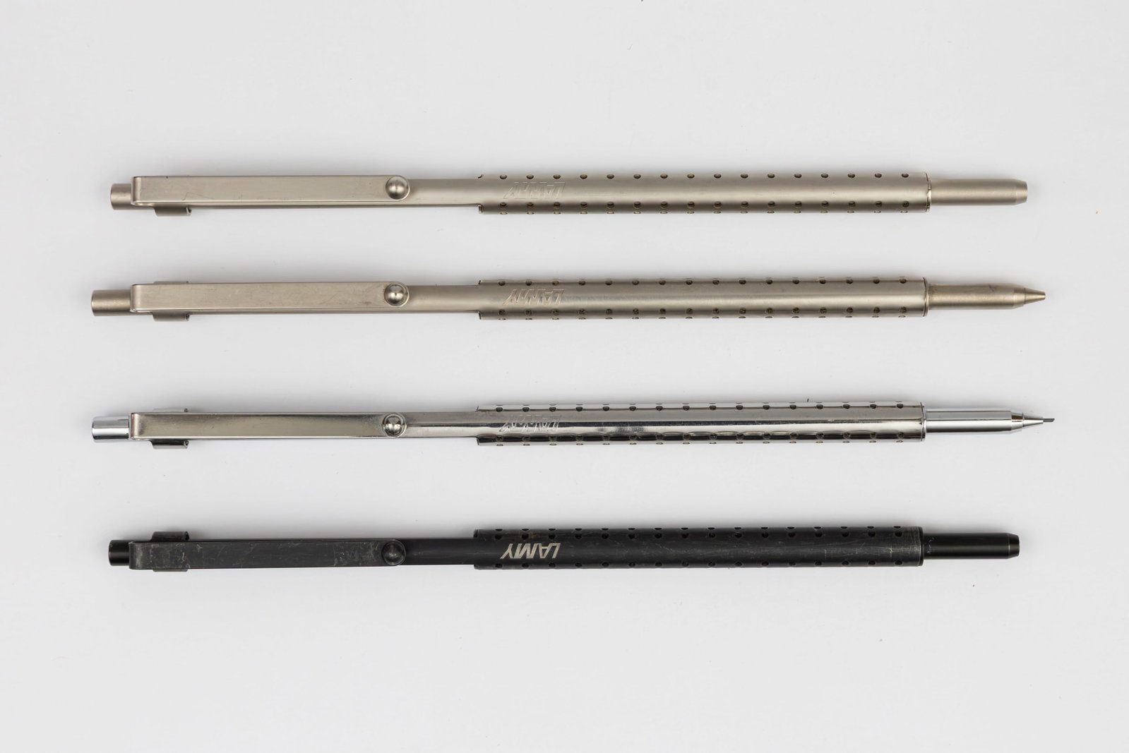 Lamy Spirit Ballpoint Pens & Pencils (4): Lamy Spirit ballpoint pens and pencils (4), circa 1994-2012. The Lamy Spirt was designed by Wolfgang Fabian, an engineering marvel being just 6mm thick. This lot includes brushed ballpoint and pencil 