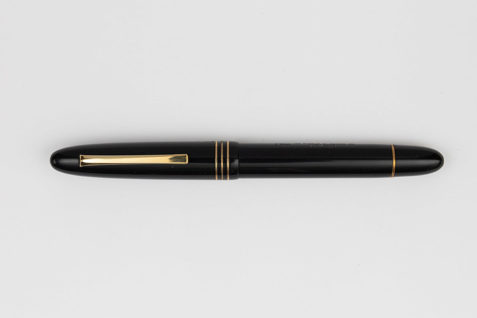 Omas MOMA Ogiva Black Fountain Pen, Boxed: Omas Ogiva MOMA fountain pen in black with gold trim with box, outer box and papers. This pen was dedicated to the Museum of Modern Art in New York, triple cap band and section with Omas two-tone 18K 