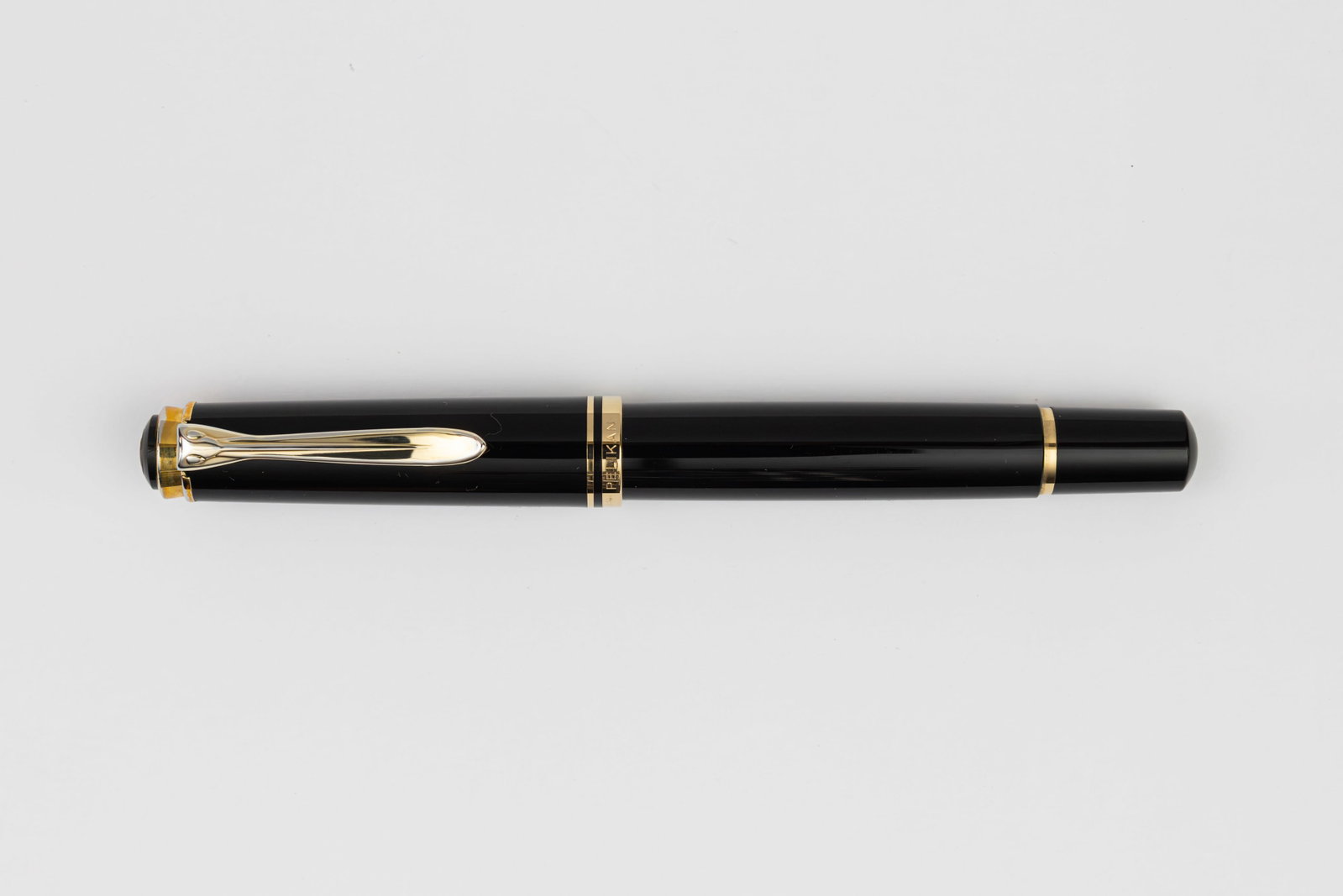 Pelikan M600 Black Fountain Pen, OB Nib, Boxed: Pelikan M600 black fountain pen, boxed, circa 1991-1997. Early single banded model marked Pelikan Germany on cap band with two-tone 14K oblique broad nib. Length 4 7/8” and 5 3/4” posted, 