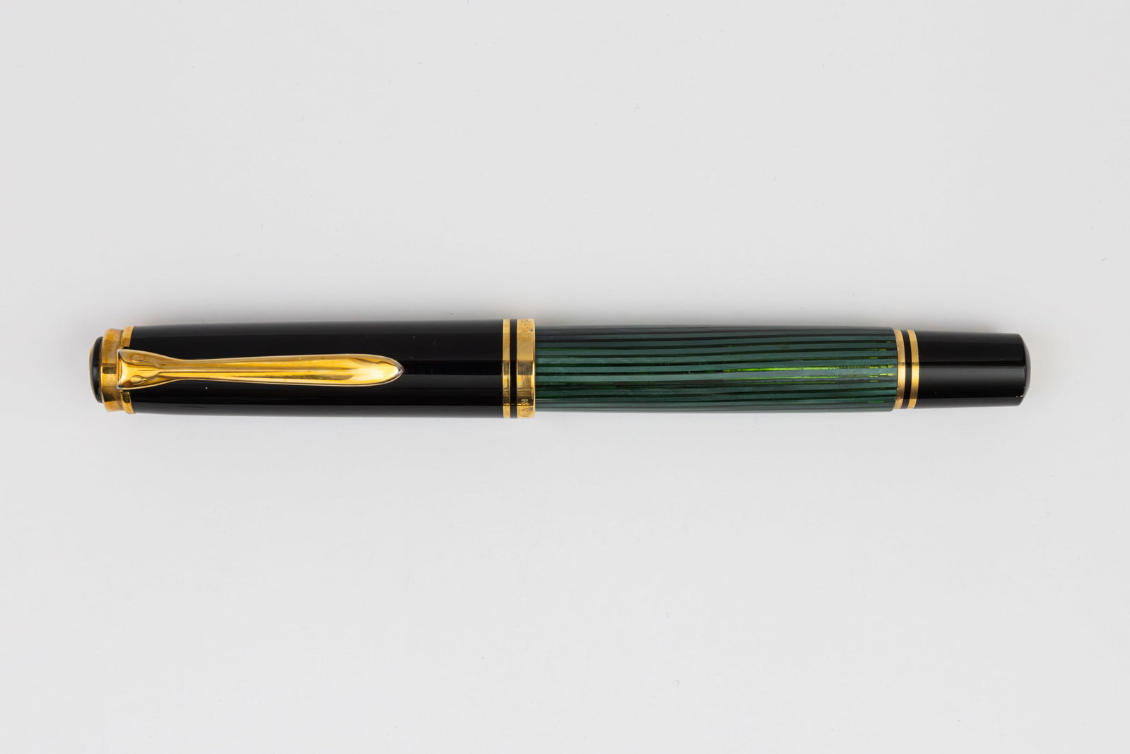 Pelikan M800 Souveran Green Striated Fountain Pen: Pelikan M800 green striated fountain pen, circa 1989-1991. An early M800 in green striated with transparent barrel, marked Pelikan W. Germany on cap band with 18K fine two-tone nib. Length 5 1/2&rdquo
