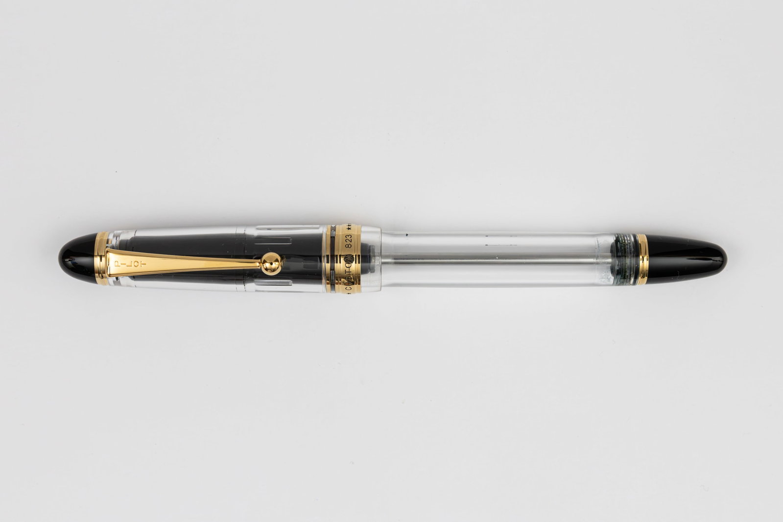 Pilot Custom 823 Demonstrator Fountain Pen: Pilot Custom 823 demonstrator fountain pen. Pilot Custom 823 gold trim demonstrator pen with 14K broad nib. Length 5 7/8” and 6 1/2” posted, filling mechanism piston fill. Overall excellen