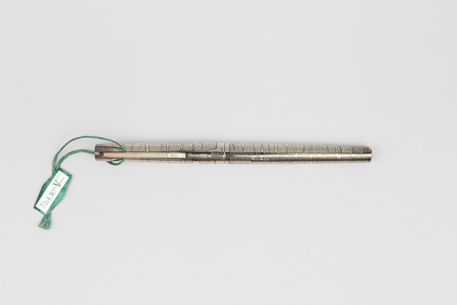 Platinum Riviere Silver Cobblestone Fountain Pen, Original Tag: Platinum Riviere Cobblestone silver fountain pen, circa 1970’s. Platinum Riviere in Cobblestone pattern with etched design in silver, marked with R on cap but no metal content markings, 18K white go
