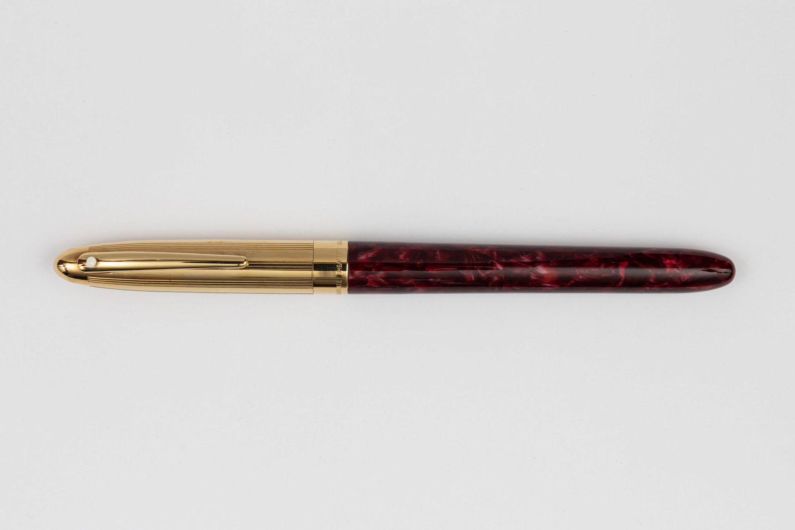 Sheaffer Crest Opalite Red & Gold Plate Fountain Pen: Sheaffer Crest Opalite Red and Gold Plate fountain pen. Bright Opalite Red Crest pen with gold plate cap and extra fine 18K nib. Length 5 1/2 inches and 5 7/8 inches posted, filling mechanism cartridg