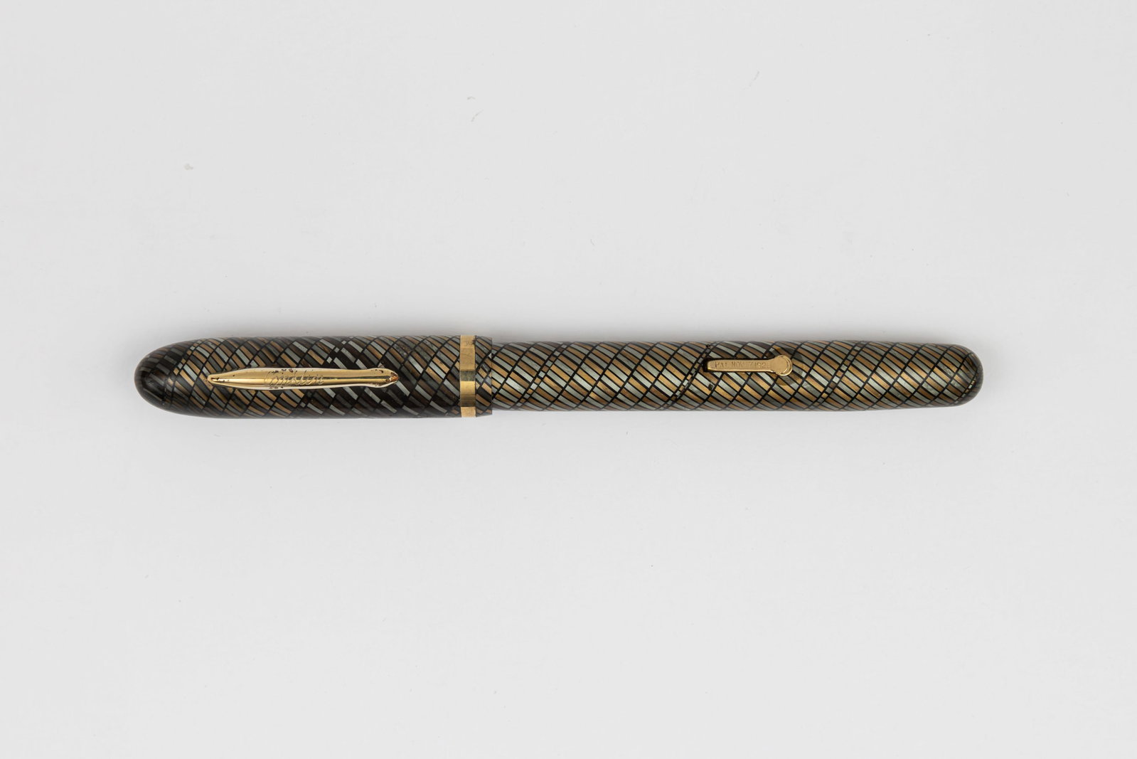 Conklin Streamline Pearl and Gold Mosaic Fountain Pen: Conklin Pearl and Gold Mosaic fountain pen, circa 1937-38. Streamlined design with helical mosaic pattern in pearl, gold and black with Conklin Toledo 14K fine flexible nib. Length 5 1/8” and 6 