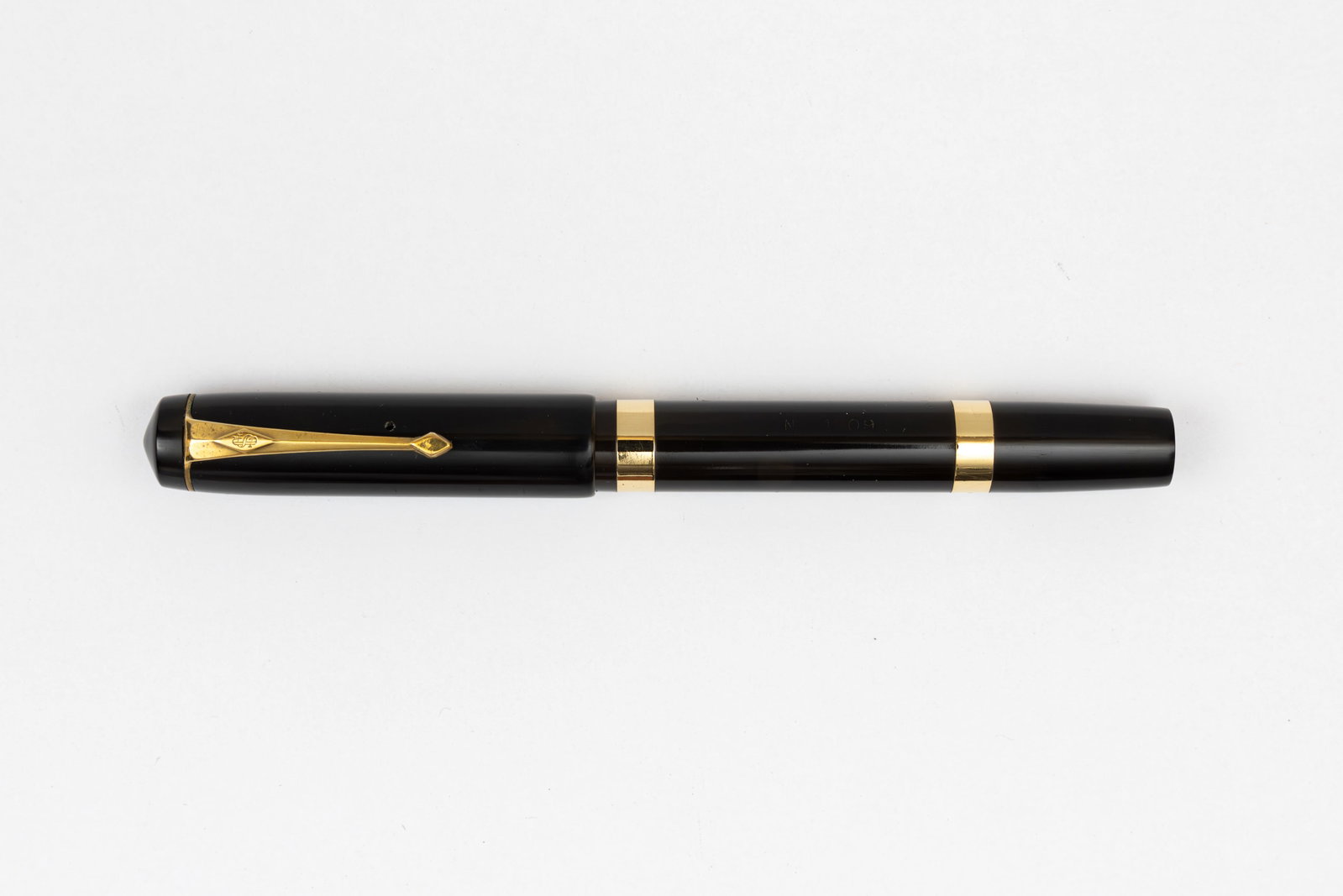 Conway Stewart 1209 Fountain Pen, Solid 9K Gold Barrel Bands: Conway Stewart 1209 black hard rubber fountain pen, circa 1930’s. Solid 9K gold barrel bands with Duro 14K fine nib. Length 5 1/8” and 6 3/8” posted, filling mechanism lever fill. Overal