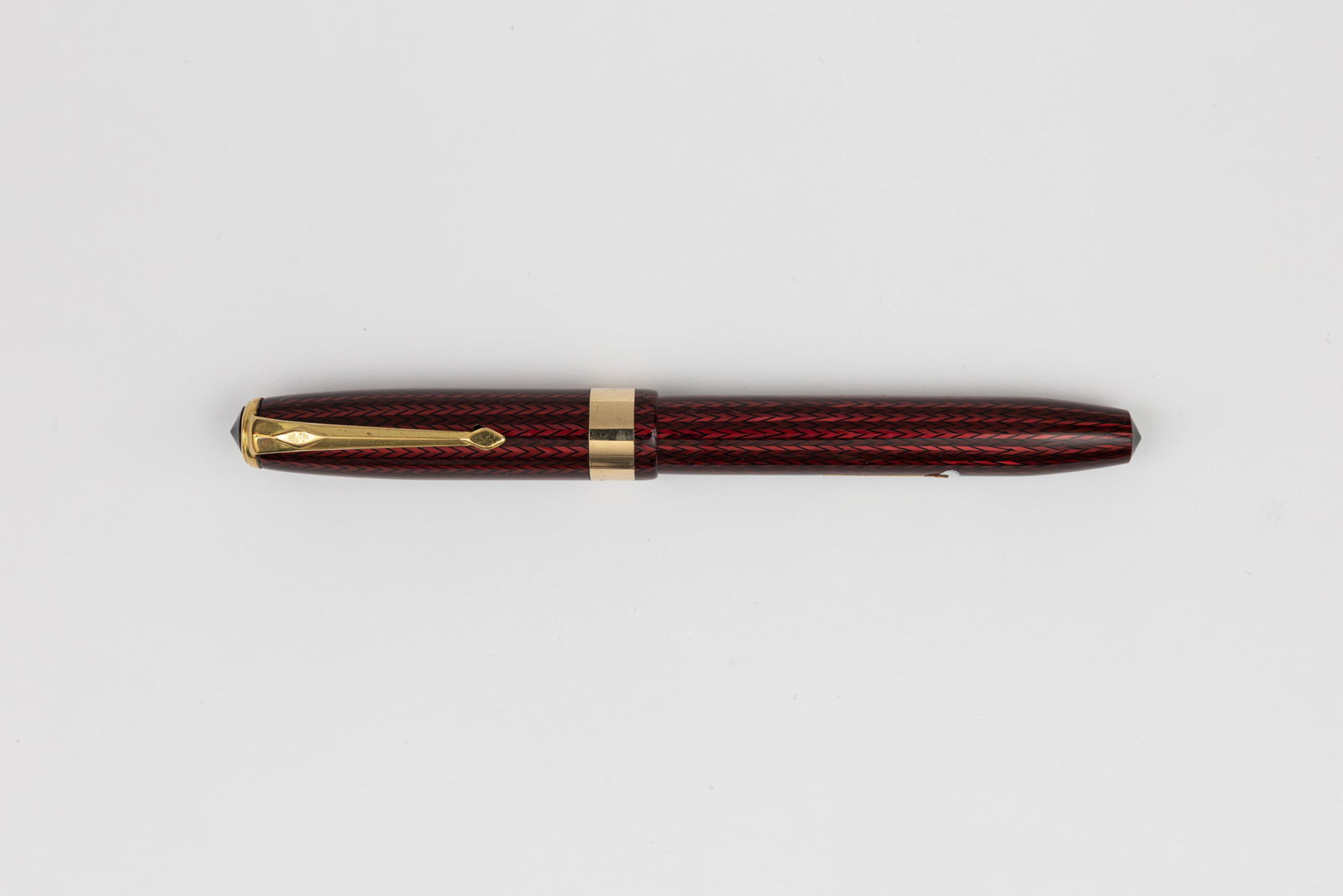 Conway Stewart 27 Red Herringbone Fountain Pen: Conway Stewart 27 model red herringbone fountain pen, circa 1950’s-60’s. Bright colour with gold filled trim, correct Conway Stewart 5 14K medium nib. Length 5” and 6 1/4” posted, fill