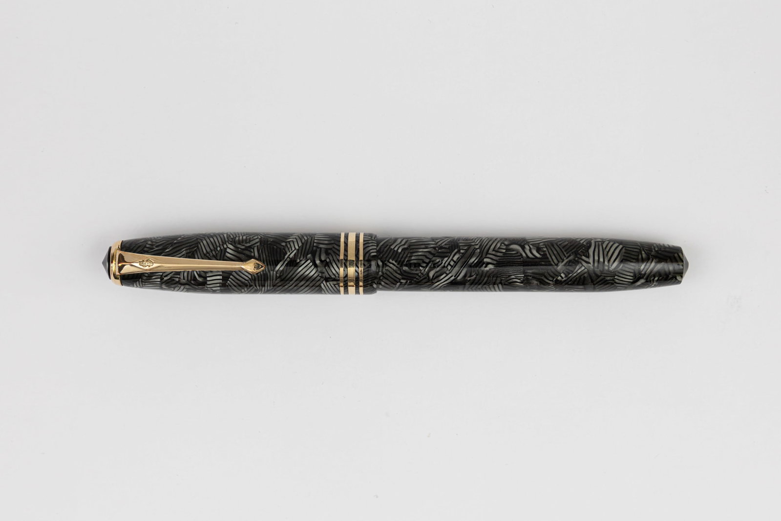 Conway Stewart 58 Grey Hatched Fountain Pen: Conway Stewart 58 Grey Hatched fountain pen, circa 1950’s. Grey Hatched pattern with gold filled trim and Conway Stewart 14K fine nib. Length 5 1/8 inches and 6 1/4 inches posted, filling mechanism 