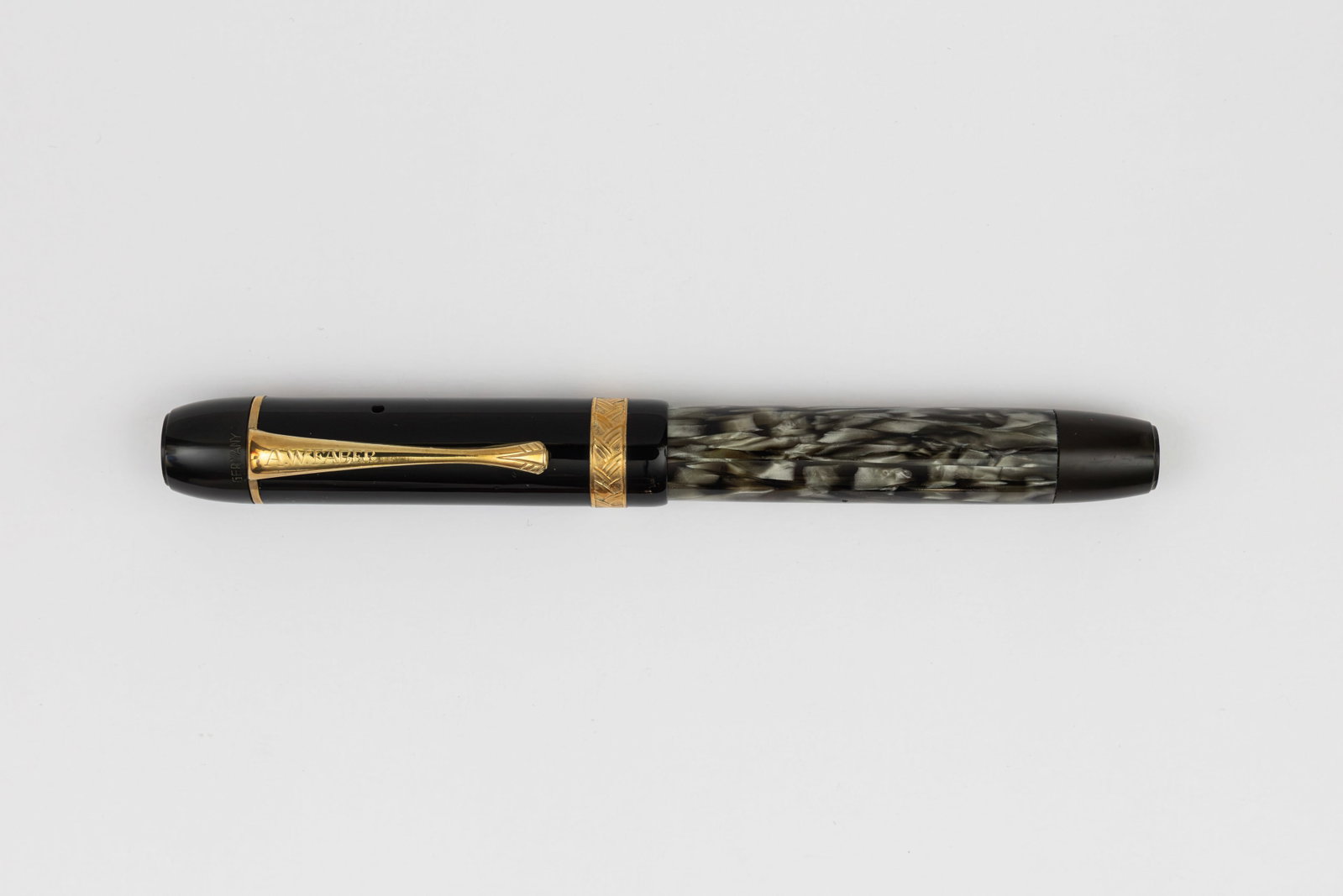 A.W. Faber-Castell Wertfüller Marbled Fountain Pen, Osmia Made: A.W. Faber-Castell Wertfüller grey/black marble fountain pen, circa 1936. Made by Osmia after acquiring the company, marked A.W. Faber on clip and Castell on cap band with green and gold scale logo o