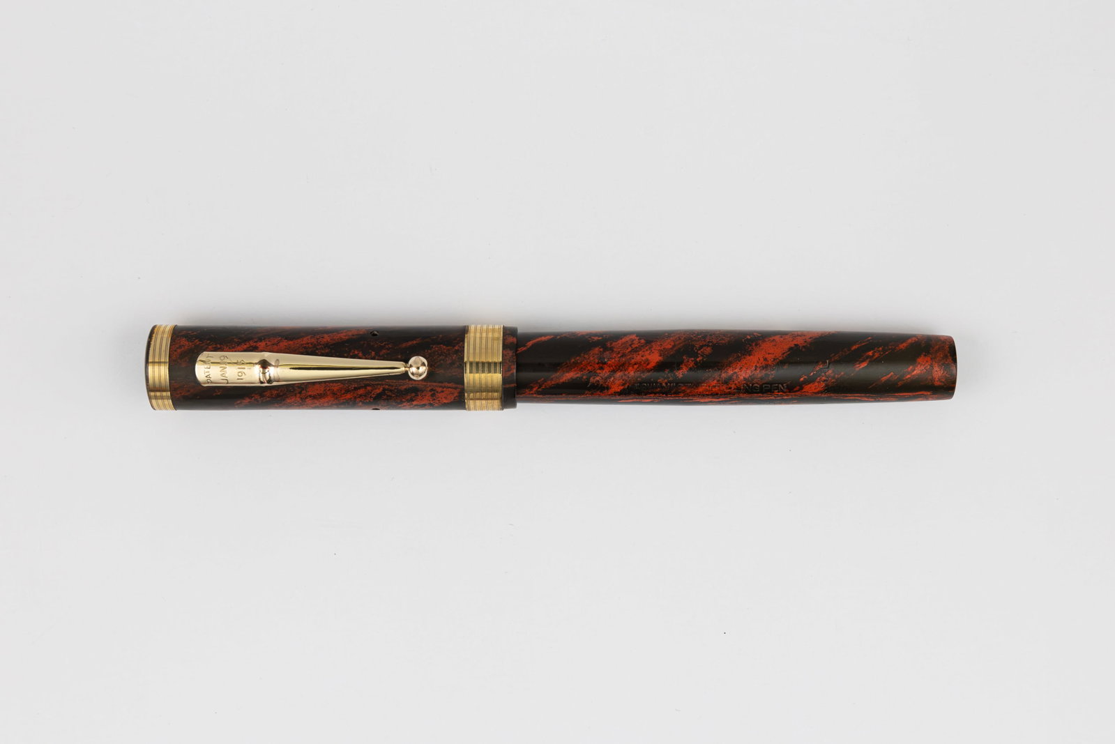Mabie Todd Swan 46 Eternal Red Mottled Hard Rubber Fountain Pen: Mabie Todd Swan 46 Eternal red mottled hard rubber fountain pen, circa 1920’s. Mabie Todd Swan 46 with gold filled upper and lower cap bands with concentric lined pattern and Swan Eternal 6 14K fine