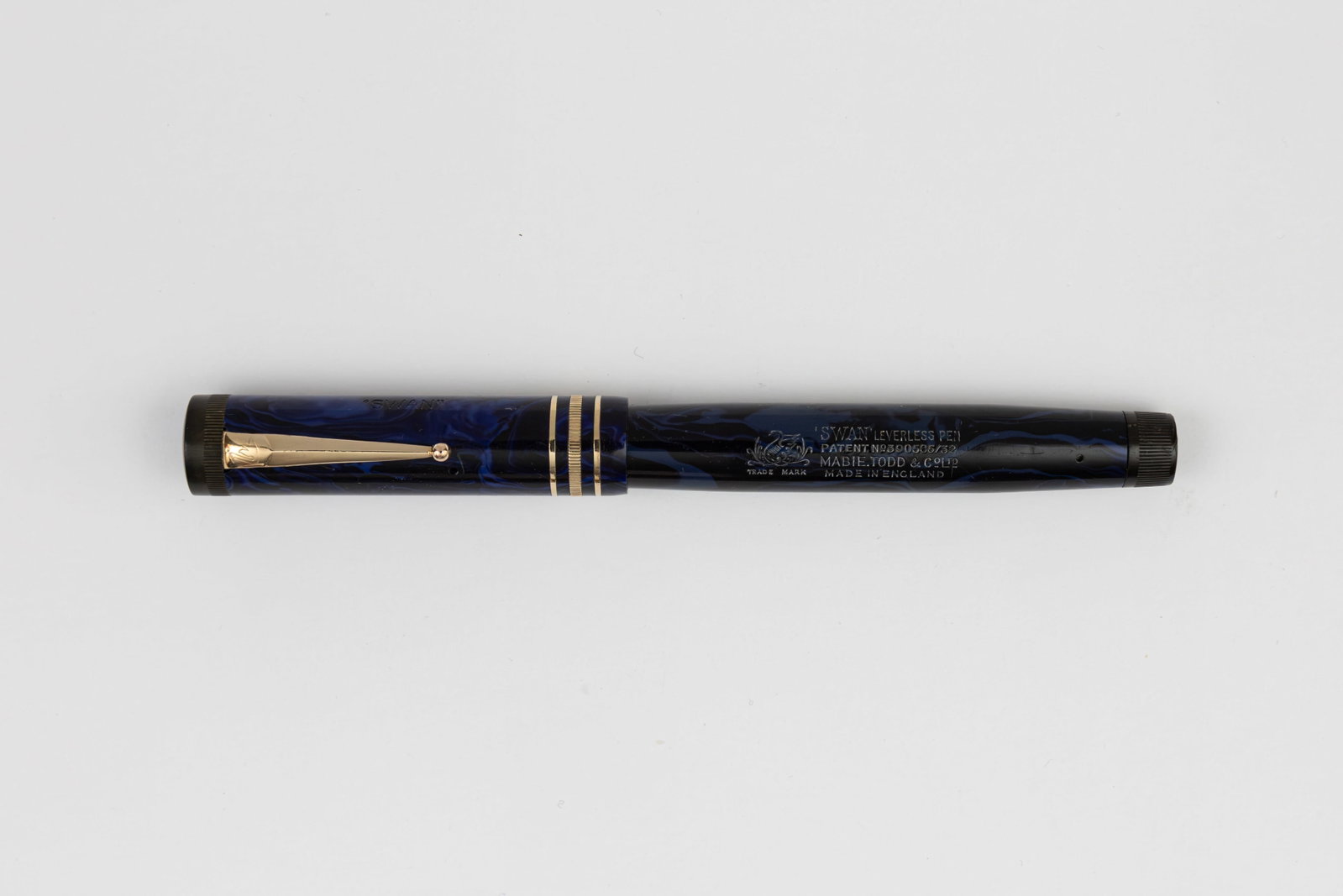 Mabie Todd Swan L245B/52 Blue Mottled Leverless Fountain Pen: Mabie Todd Swan L245B/52 Blue Mottled Leverless fountain pen. Bright colour and imprints with triple cap band and Swan 2 14K medium flexible nib. Length 5” and 6 1/8” posted, filling mecha