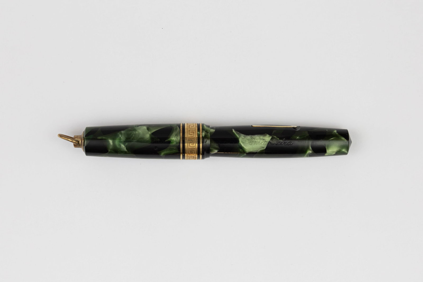 Omas Extra Green Marble Ring Top Fountain Pen: Omas Extra green marble ring top fountain pen, circa 1932. Omas round Extra with fretted cap band, this example in green marble, ring top model with Omas Extra 14K extra fine flexible nib. Length 3 3/