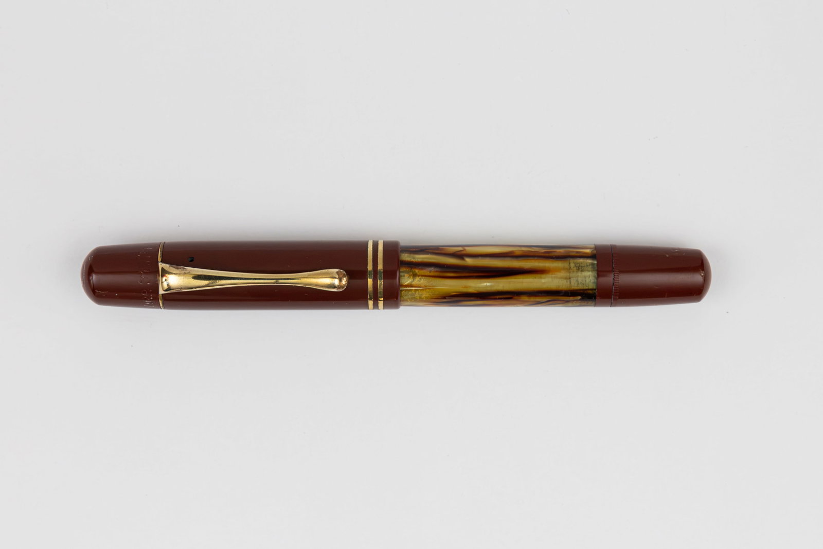 Pelikan 101N Tortoise Brown Fountain Pen: Pelikan 101N Tortoise Brown fountain pen, circa 1937-1951. Tortoise colour with red hard rubber cap and matching end with Pelikan 14K fine flexible nib. Length 4 3/4” and 6 1/8” posted, fi