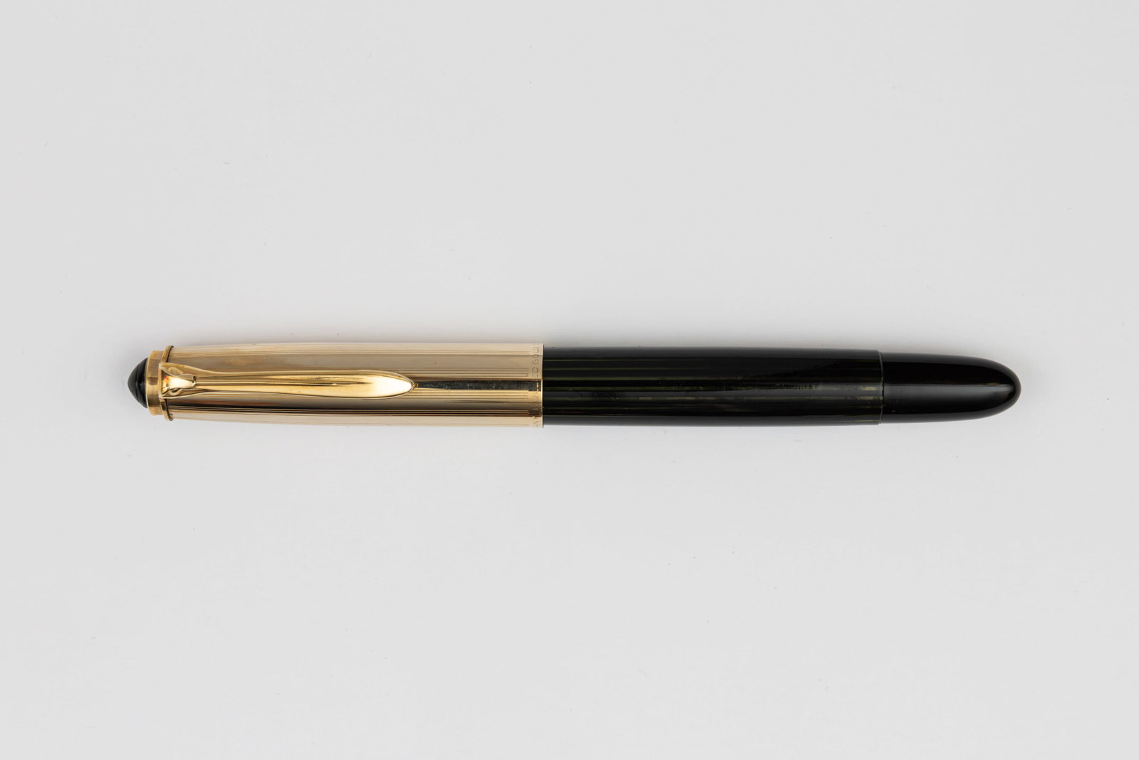 Pelikan 500NN Black Gold Filled Cap Fountain Pen: Pelikan 500NN black striated fountain pen, circa 1956-63. The 500NN is the longer and more slender model of the 400 series from the 1950s coming to a point on either end. The 500NN with gold filled ca