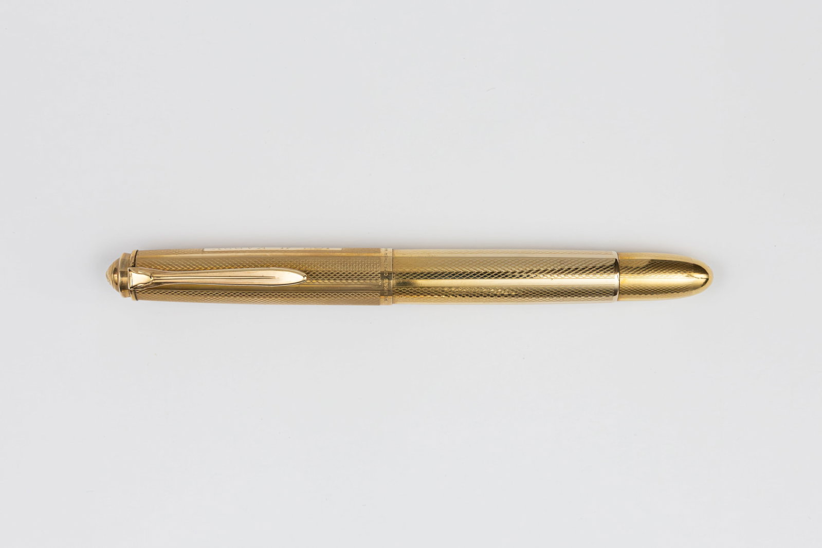 Pelikan 520NN Gold Filled Fountain Pen: Pelikan 520NN rolled gold double fountain pen, circa 1957-63. Gold filled barleycorn pattern with Pelikan 14K extra fine nib. Length 5 3/16” and 5 7/8” posted, filing mechanism piston fill