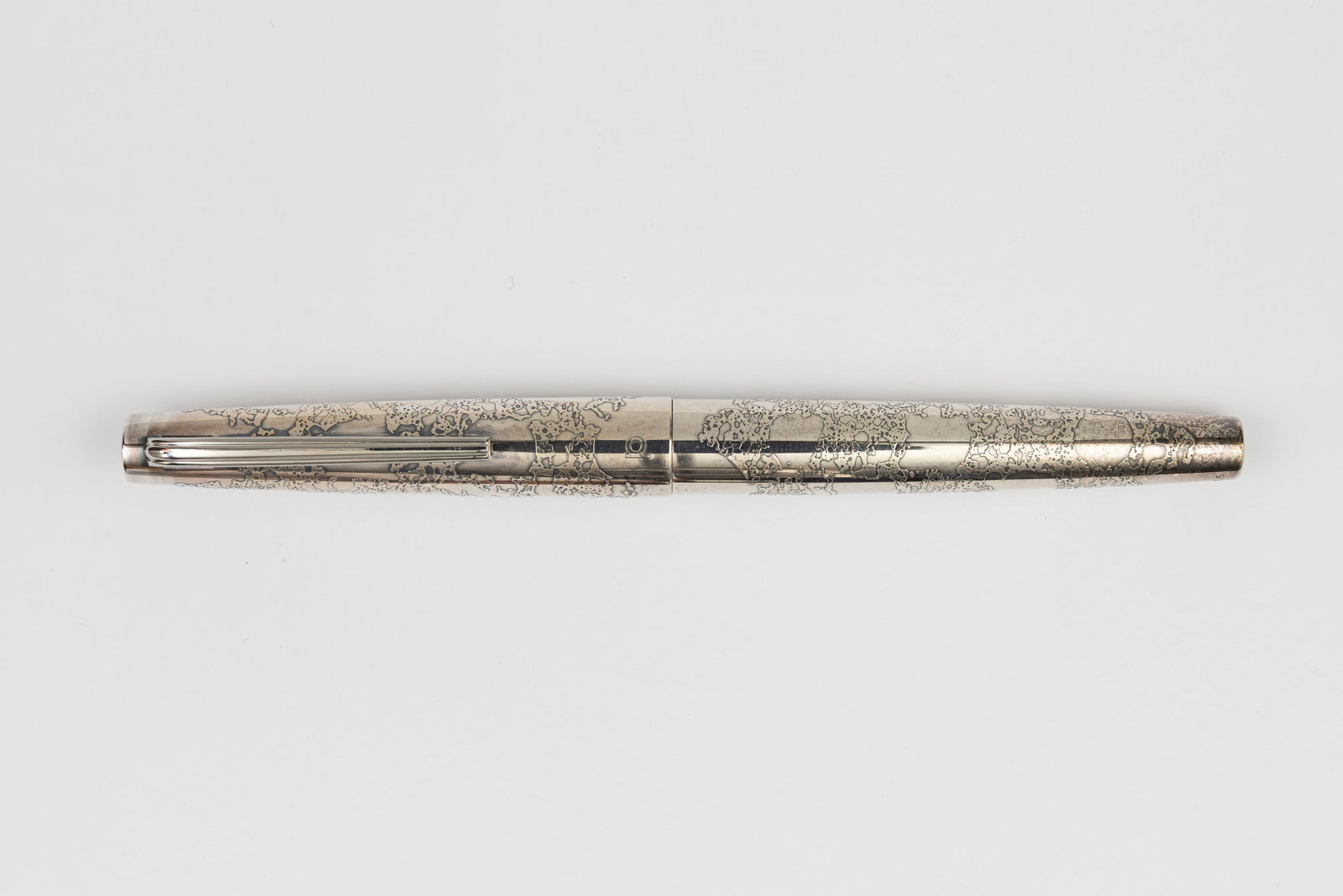Platinum Ginga Galaxy Etched Sterling Silver Fountain Pen: Platinum Ginga Galaxy etched sterling silver fountain pen, circa 1970’s. Platinum Ginga in Galaxy pattern with etched design, marked sterling silver on cap with 18K white gold medium Platinum nib an