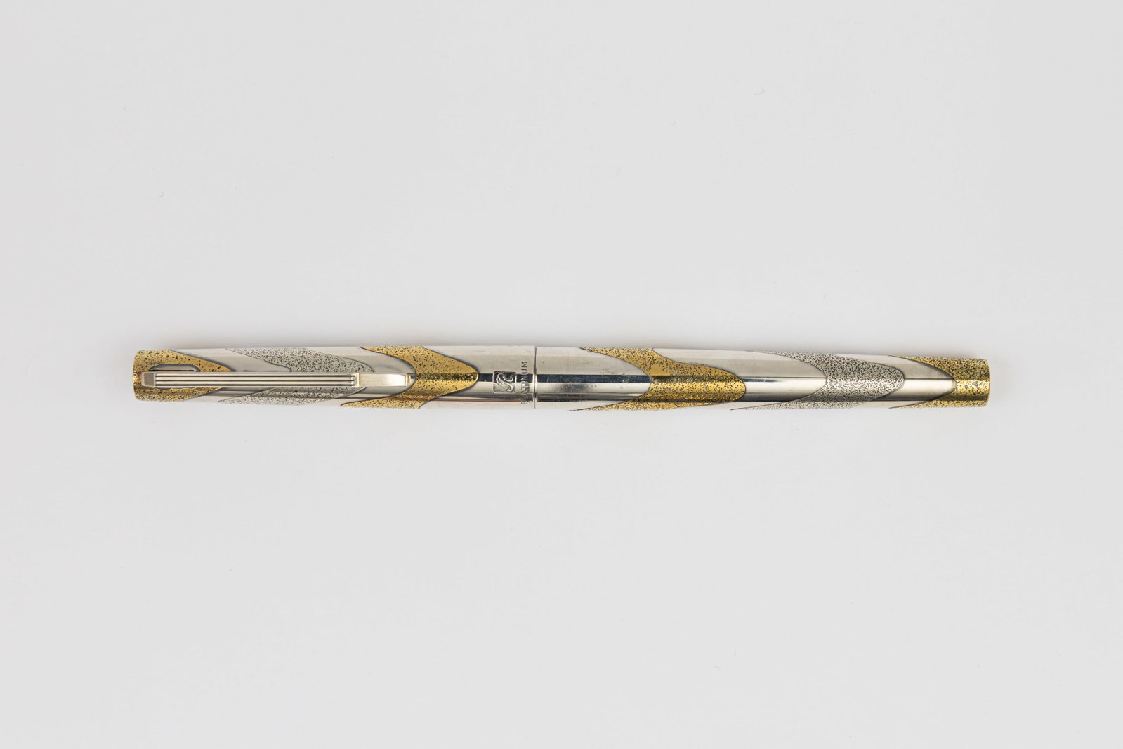 Platinum Riviere Waves and Wind Sterling Silver, Gold Fountain Pen: Platinum Riviere Waves and Wind sterling silver and gold fountain pen, circa 1970’s Platinum Riviere Waves and Wind pattern in silver and gold, marked sterling silver on cap with R for Riviere model