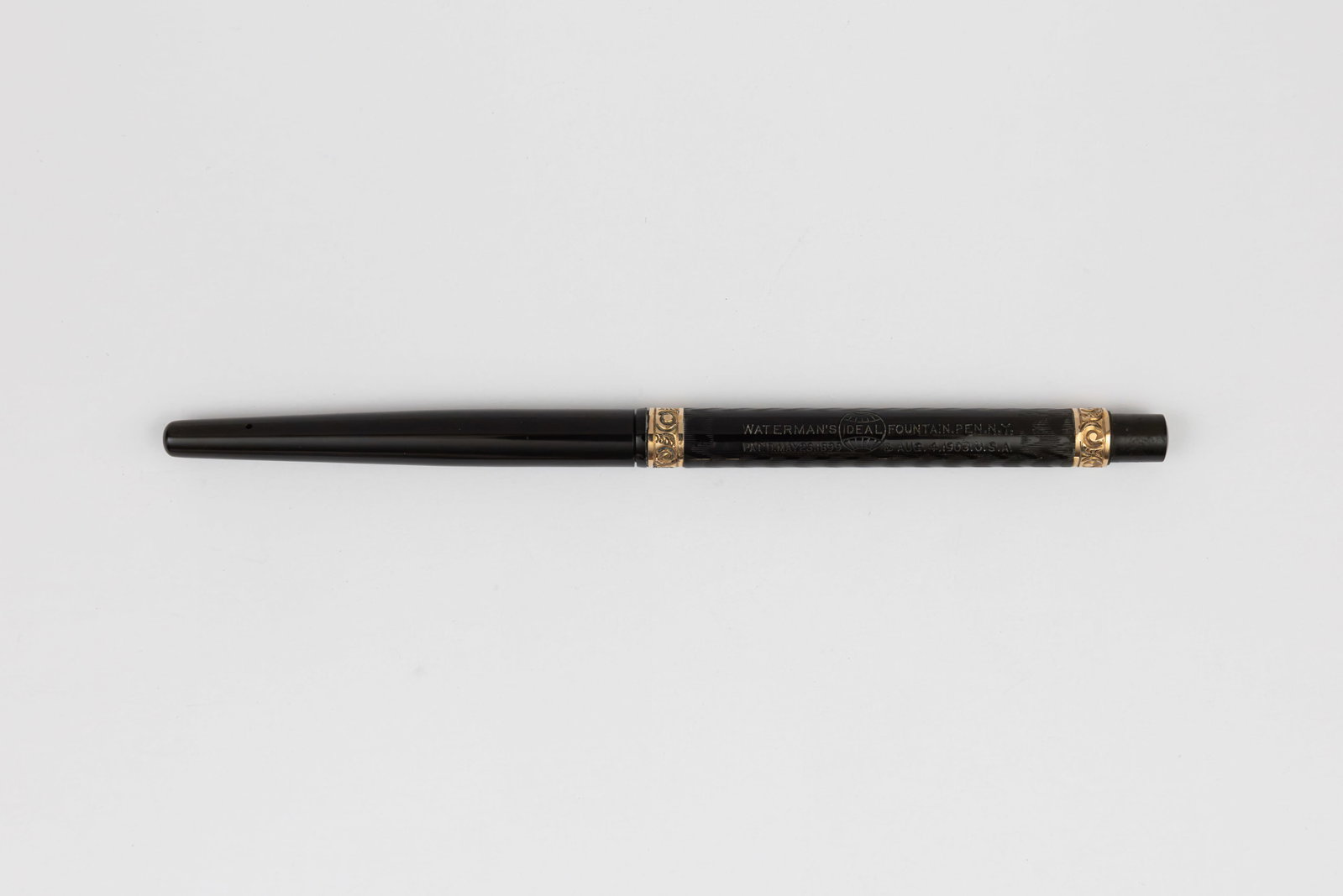 Waterman 22 Taper Cap Black Chased Hard Rubber Fountain Pen: Waterman 22 taper cap black chased hard rubber fountain pen gold filled chased bands, circa 1905-1915. Waterman 22 taper cap fountain pen with gold filled chased bands in black chased hard rubber, 189