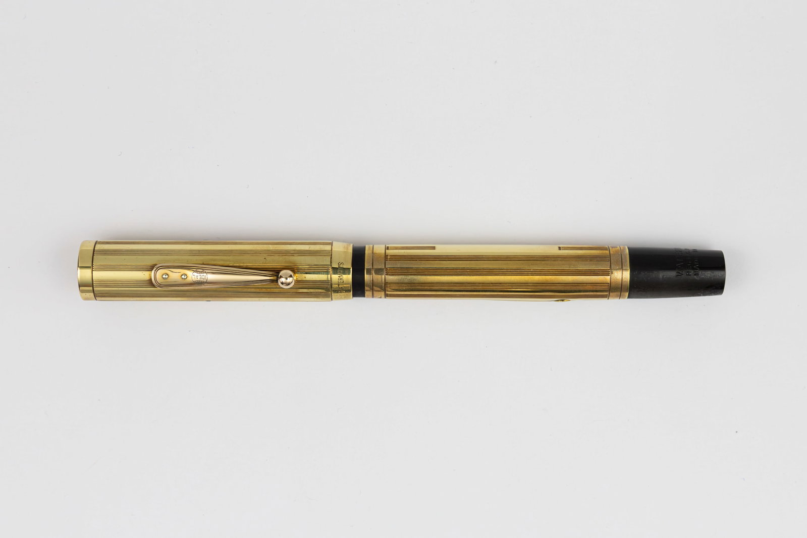Waterman 0552 Sheraton Gold Filled Overlay Fountain Pen: Waterman Ideal 0552 Sheraton gold filled overlay fountain pen, circa 1920’s. Sheraton lined pattern gold filled overlay over black hard rubber with gold filled clip with lined design and Waterman Id