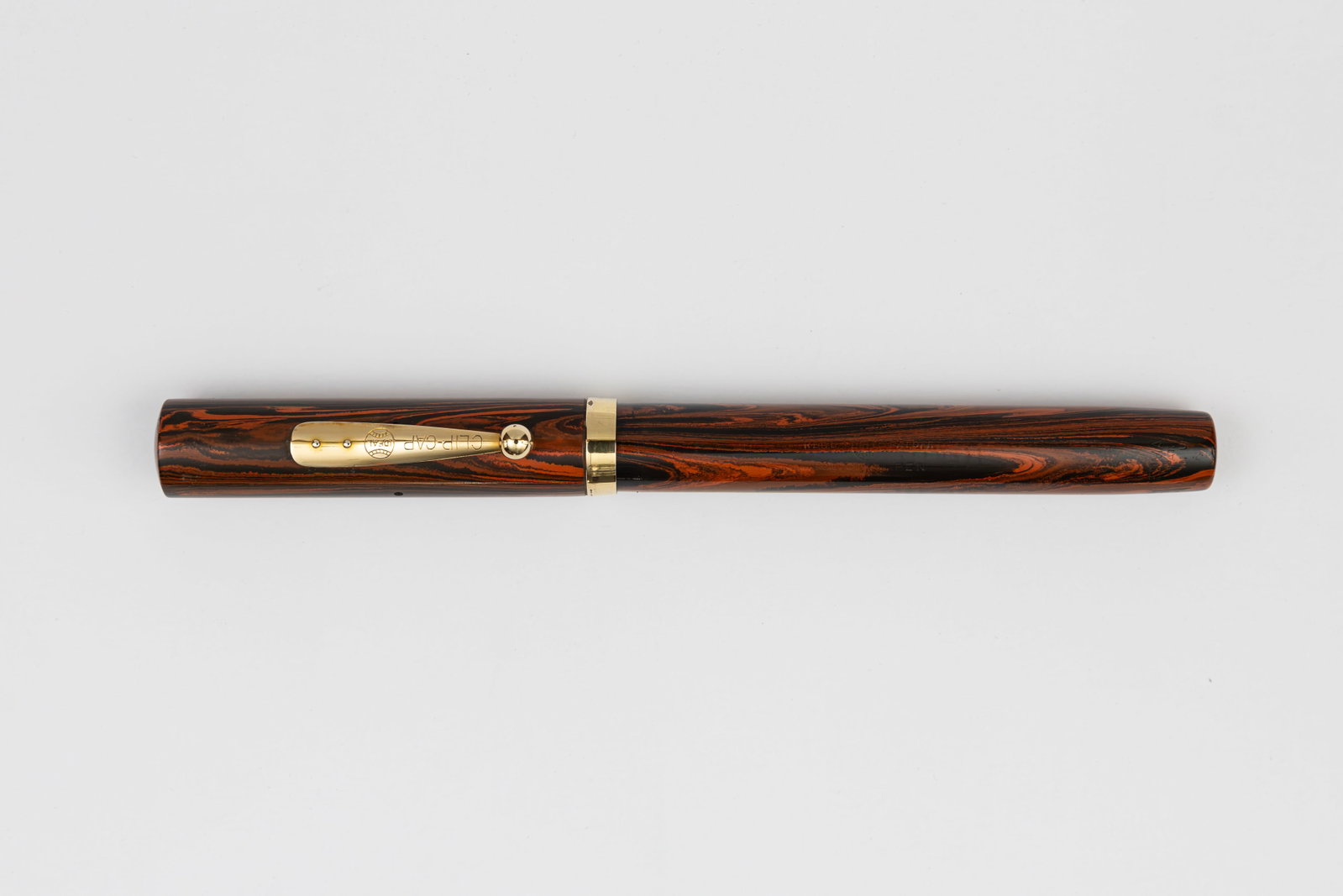 Waterman 55 Red Mottled Hard Rubber Fountain Pen: Waterman Ideal 55 red mottled hard rubber woodgrain fountain pen, circa 1920’s. Waterman 55 woodgrain pattern fountain pen with Waterman Ideal 5 14K extra fine flexible nib with black hard rubber fe