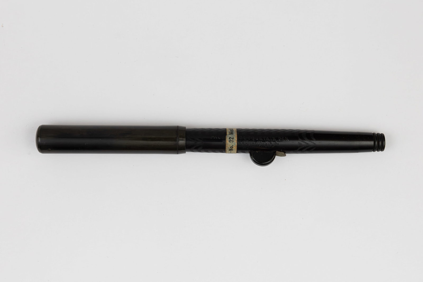 Wirt 32 Self-Filling Black Chased Hard Rubber Hump Filler Fountain Pen: Paul E Wirt No. 32 black chased hard rubber hump filler fountain pen, circa 1910. Wirt hump filler fountain pen, end unscrews to allow the hump to be compressed to fill the pen. Original price band ma