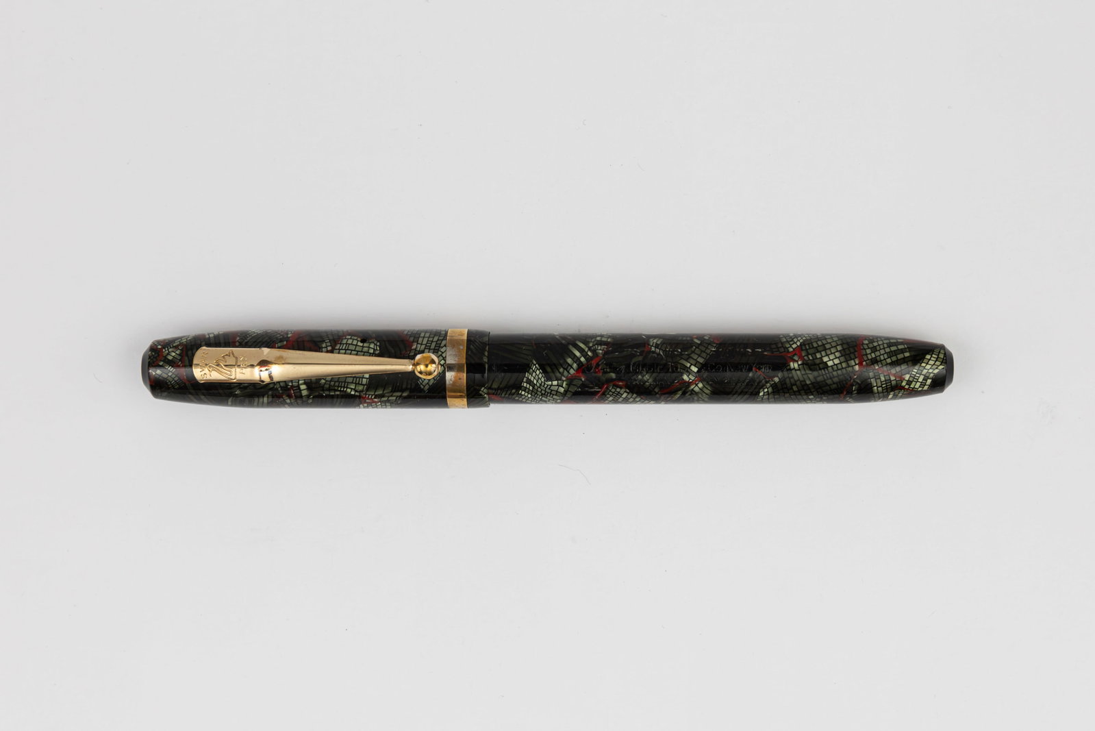 Mabie Todd Swan Green/Red Snakeskin Pattern Fountain Pen: Mabie Todd Swan green and red snakeskin pattern fountain pen. New York production with tapered ends, green and red snakeskin pattern with 14K fine flexible nib. Length 5 1/8” and 6” posted